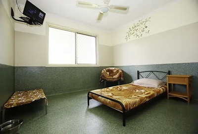 A luxury room showing human beds and tv with space for multiple pets at Pet Resorts Australia Samford