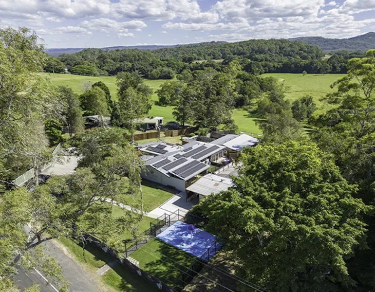 A drone shot from above showing the rolling hills of the sunshine coast surrounding the premium pet and dog boarding facility in Eumundi