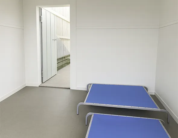 A social resort room with two beds and outdoor courtyard at Welcome Kennels
