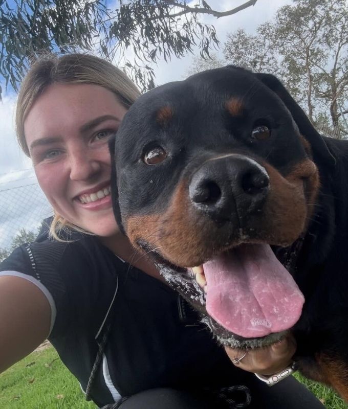 Tahlia Pet Resorts Australia Southern Highlands Manager with happy Rottweiler