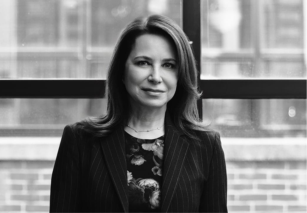 Black and white photo of a woman in front of a window