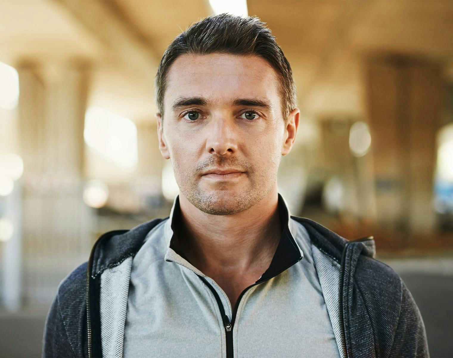man standing under an overpass