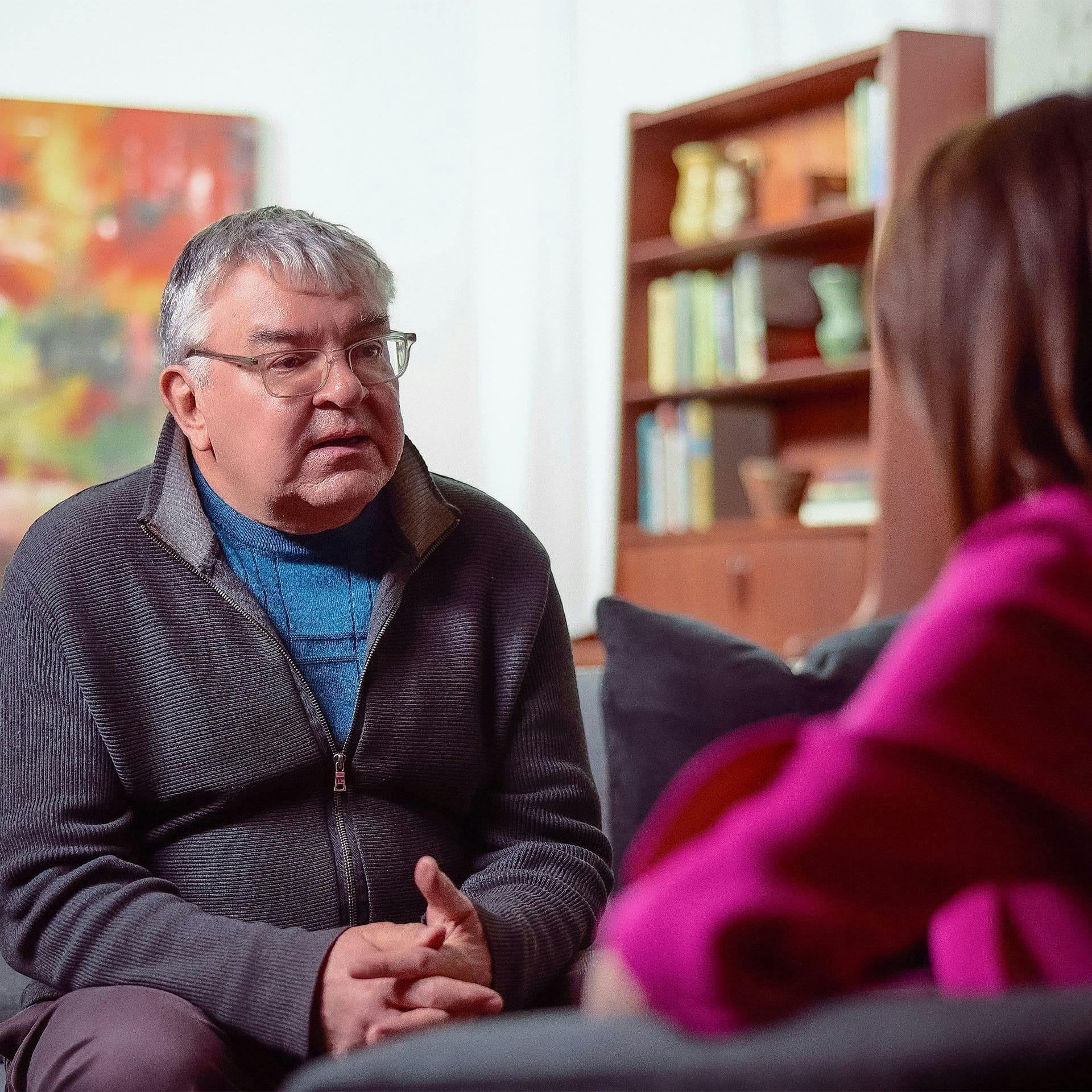 older man talking to a woman