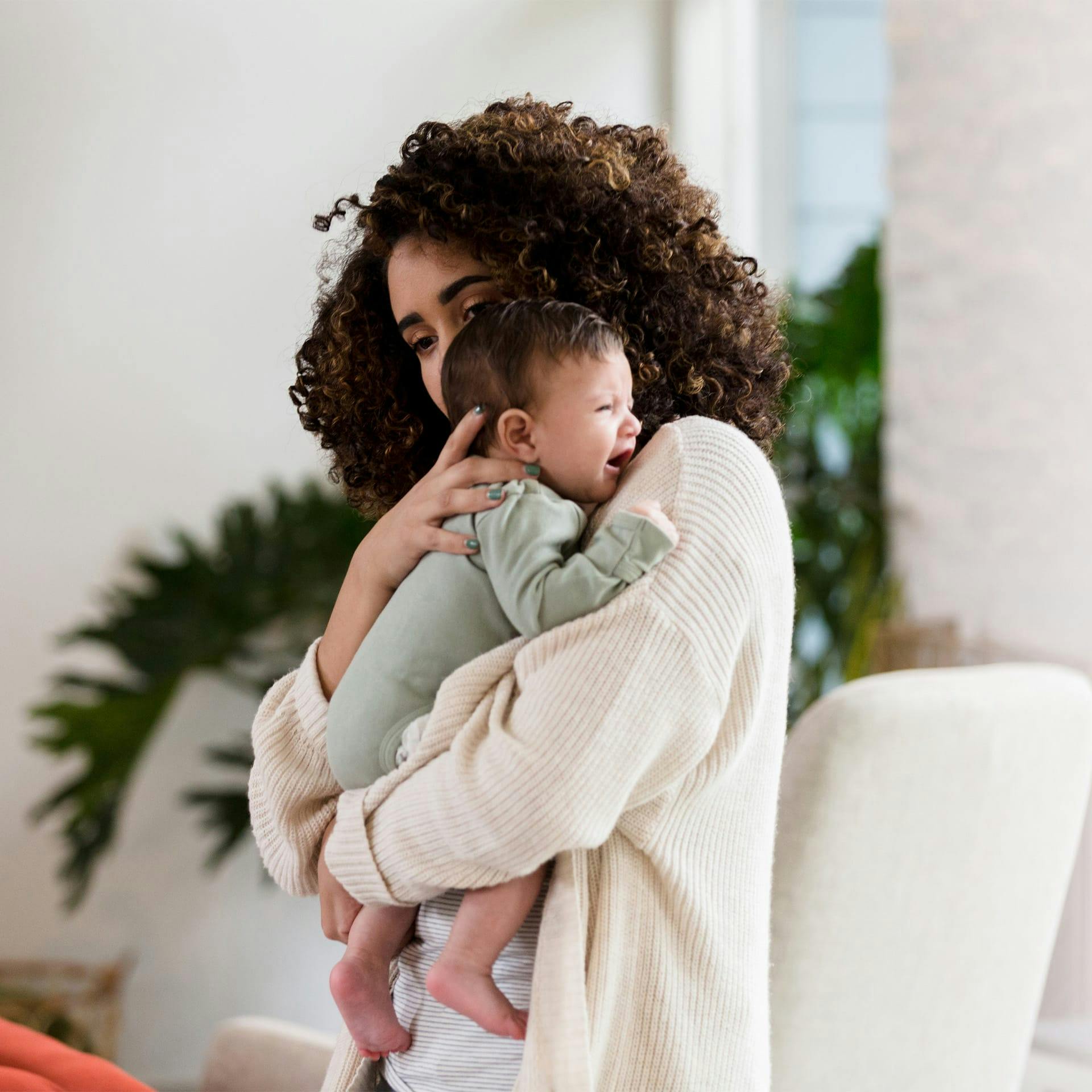 woman holding a crying baby