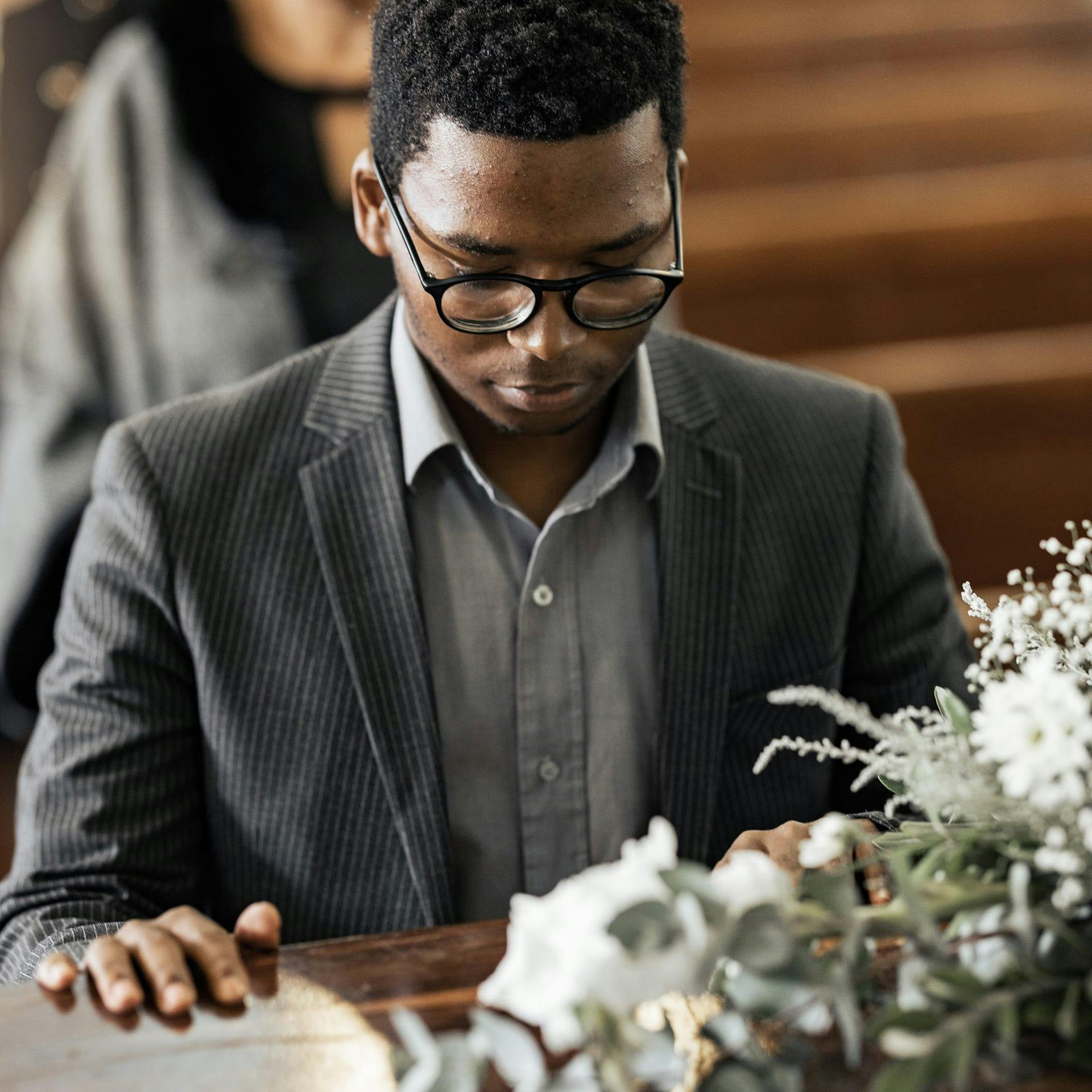 man touching a casket