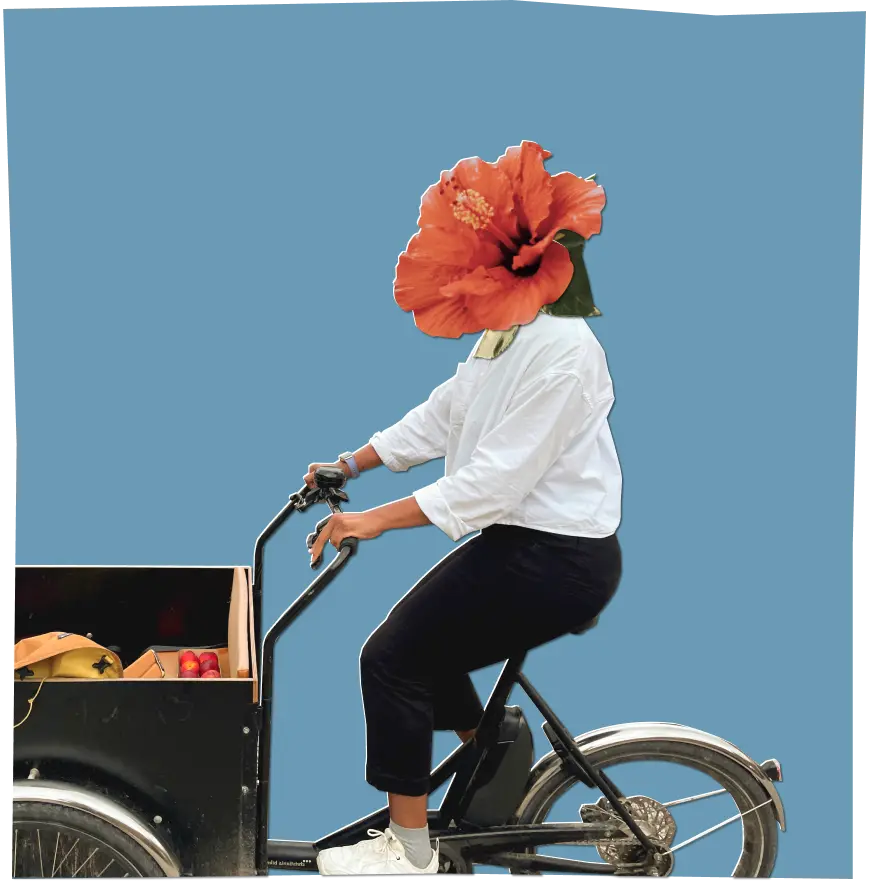 Amber riding a cargo bike, her head is replaced by a hibiscus flower