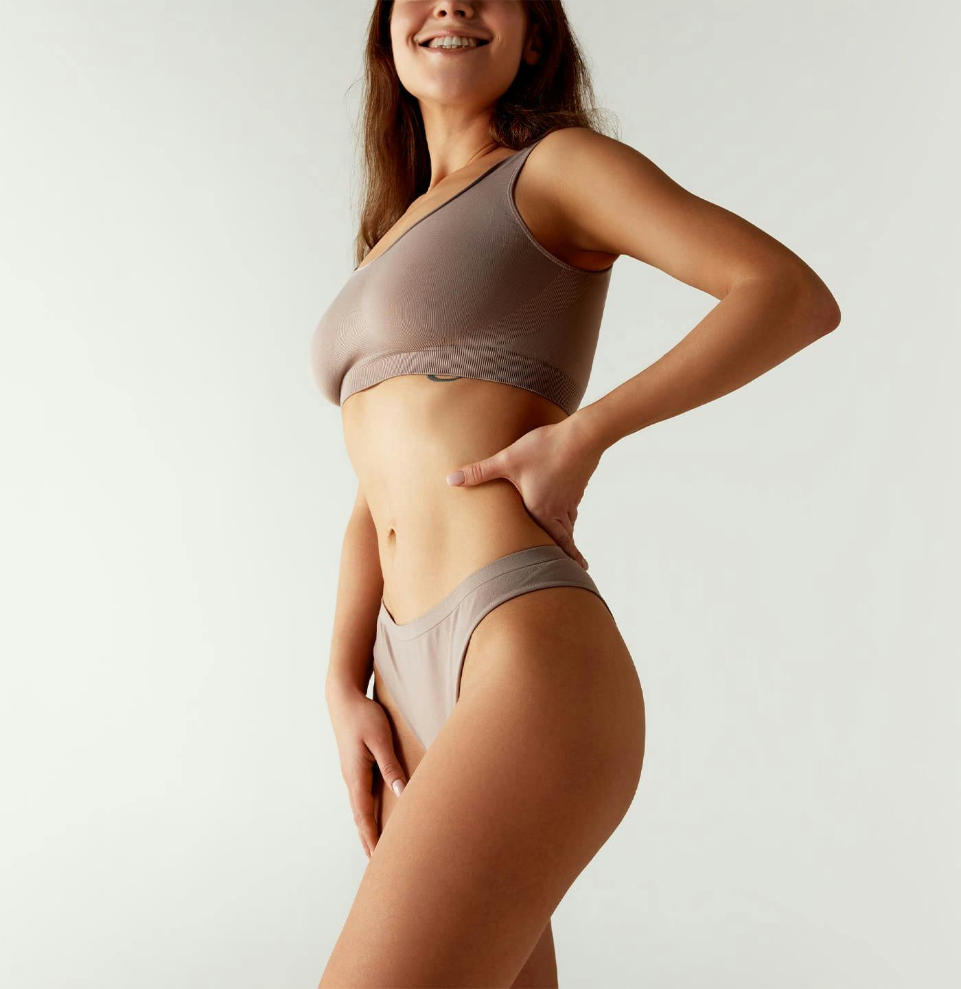 Woman smiling with hand on hip