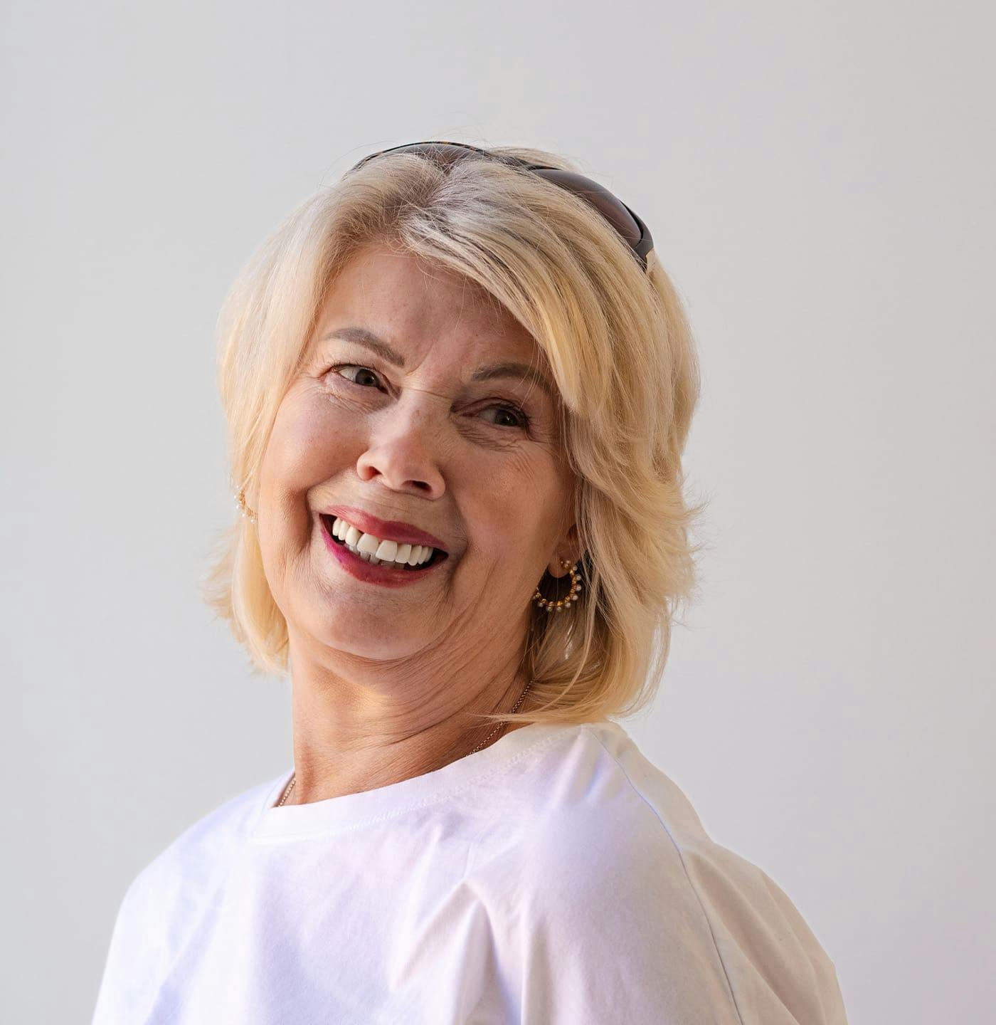 Woman laughing with sunglasses on head