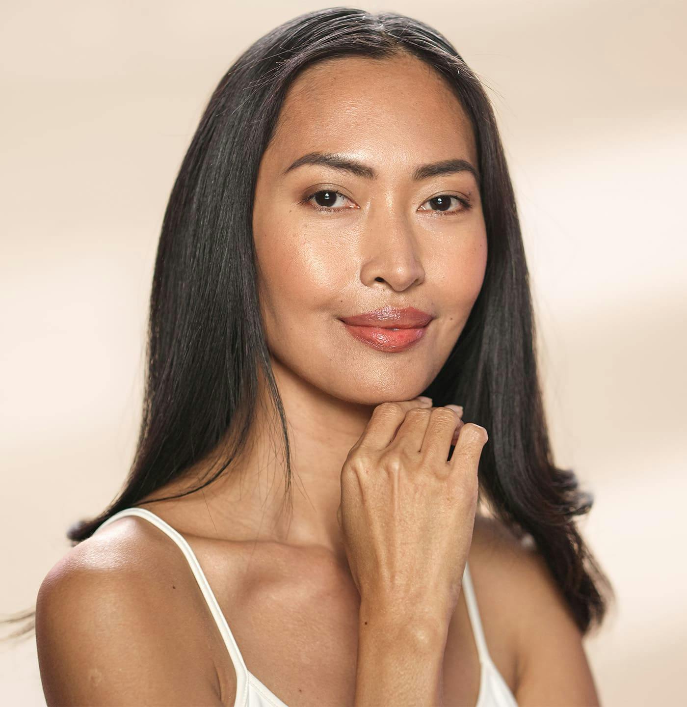 Woman smiling with hand on chin