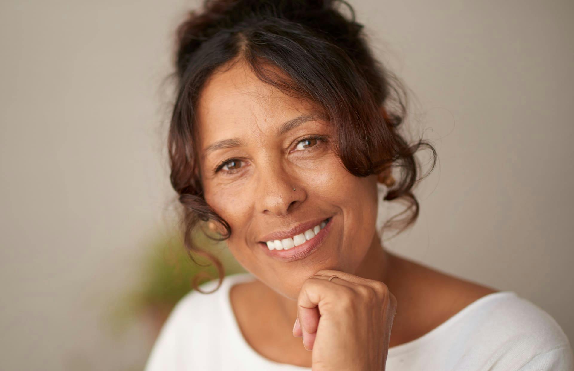 Woman smiling and touching chin