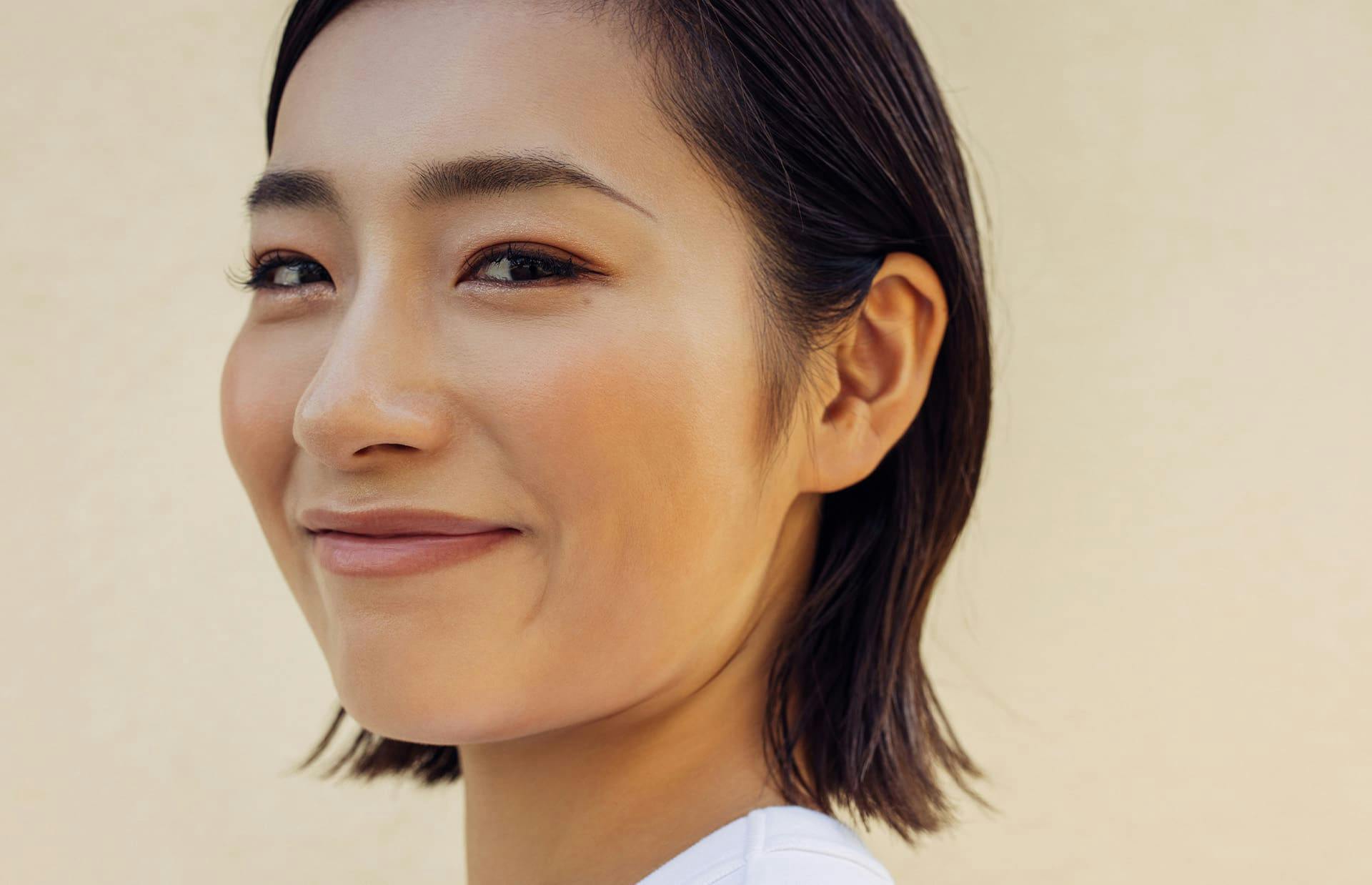 Woman smiling while looking over shoulder