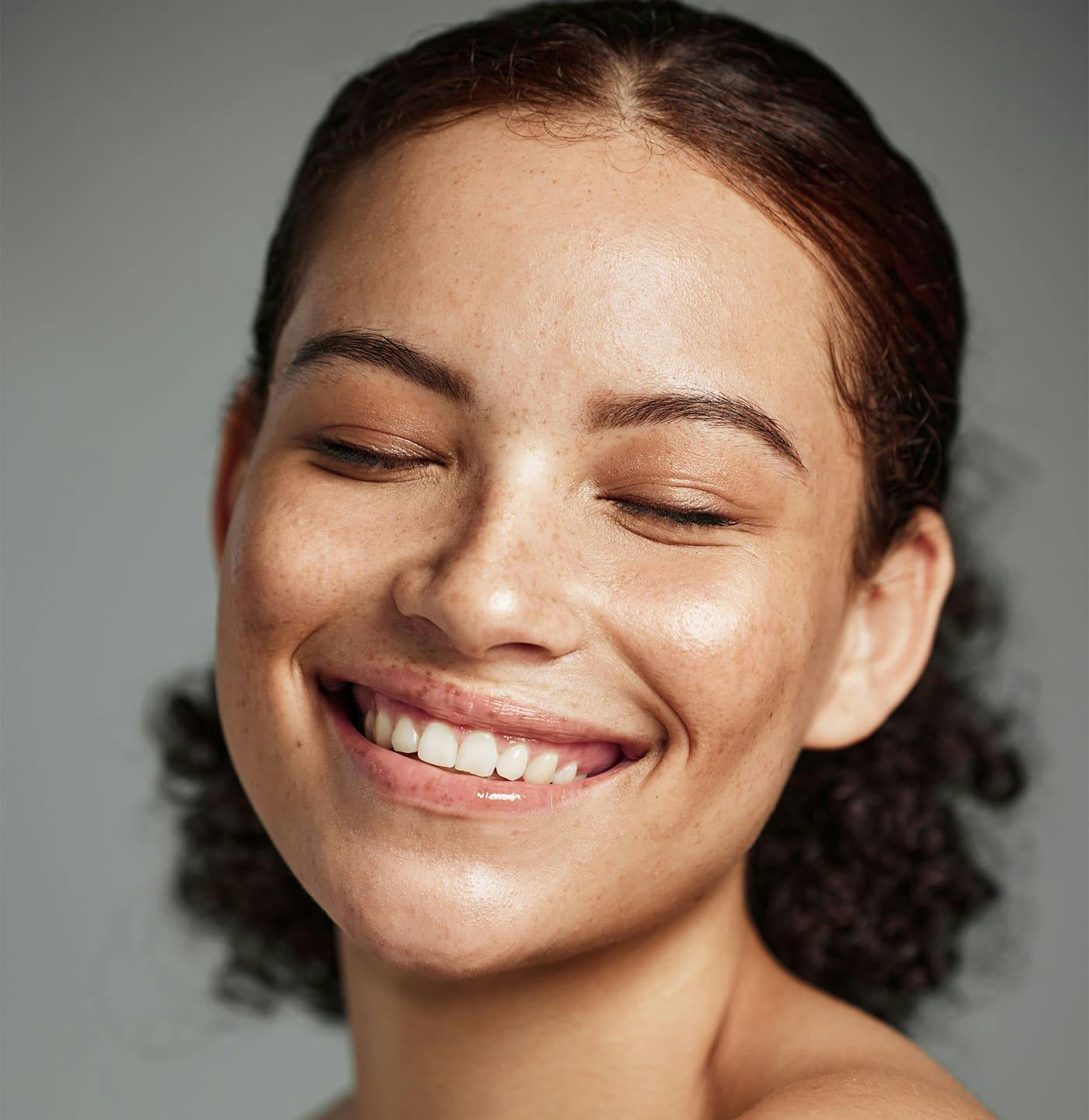 Woman smiling with eyes closed