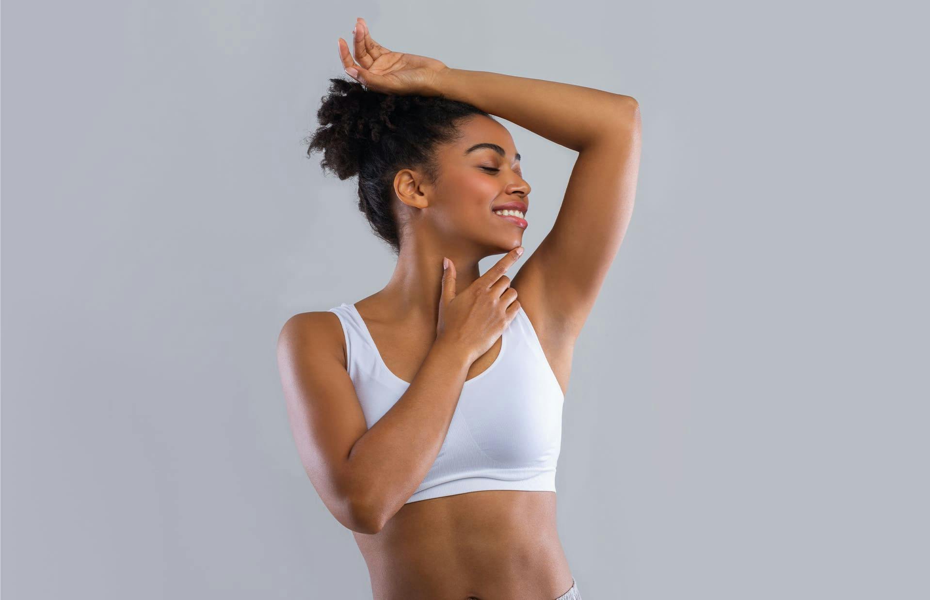Woman smiling with arms raised