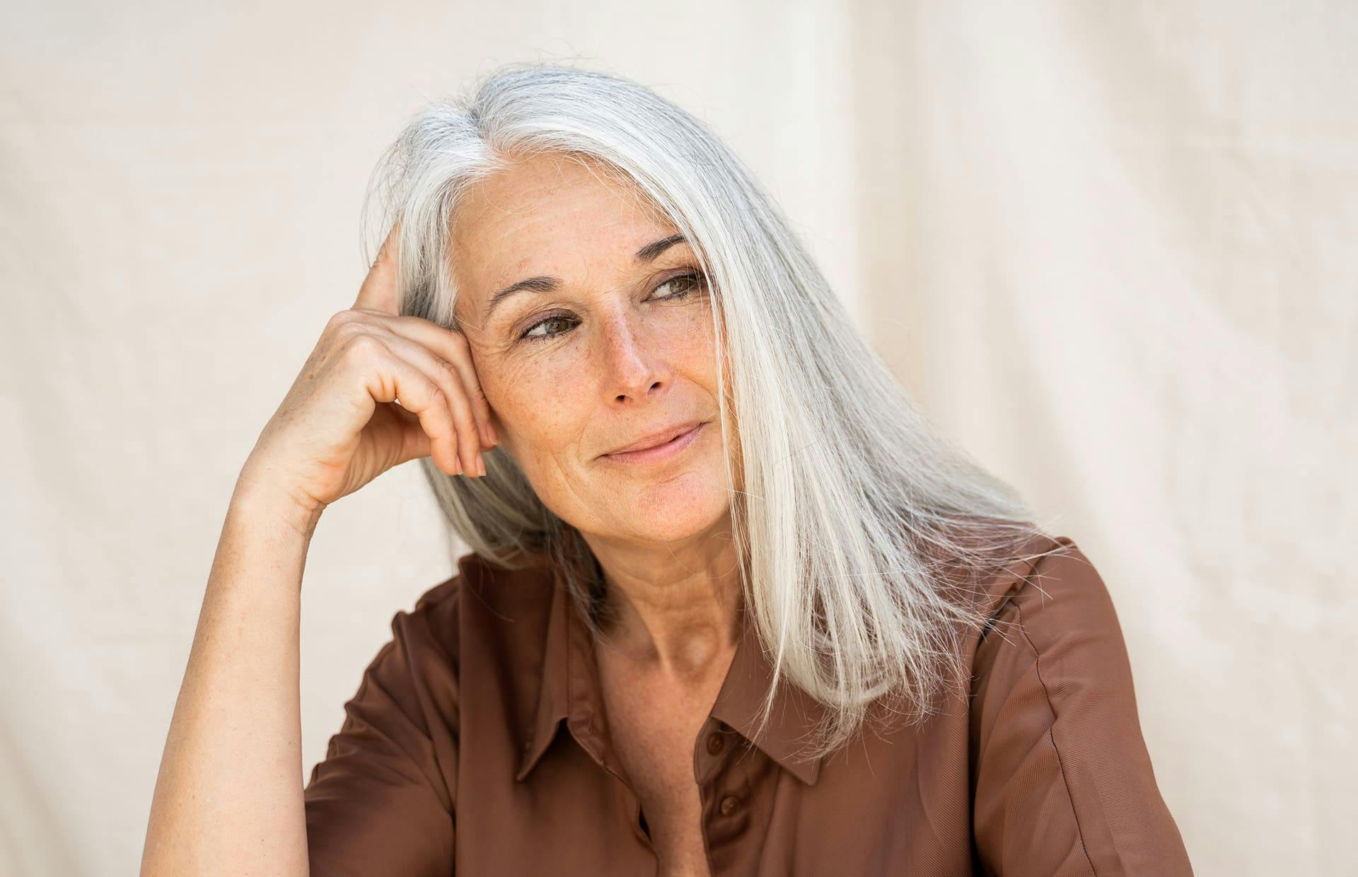 Older woman resting head on hand