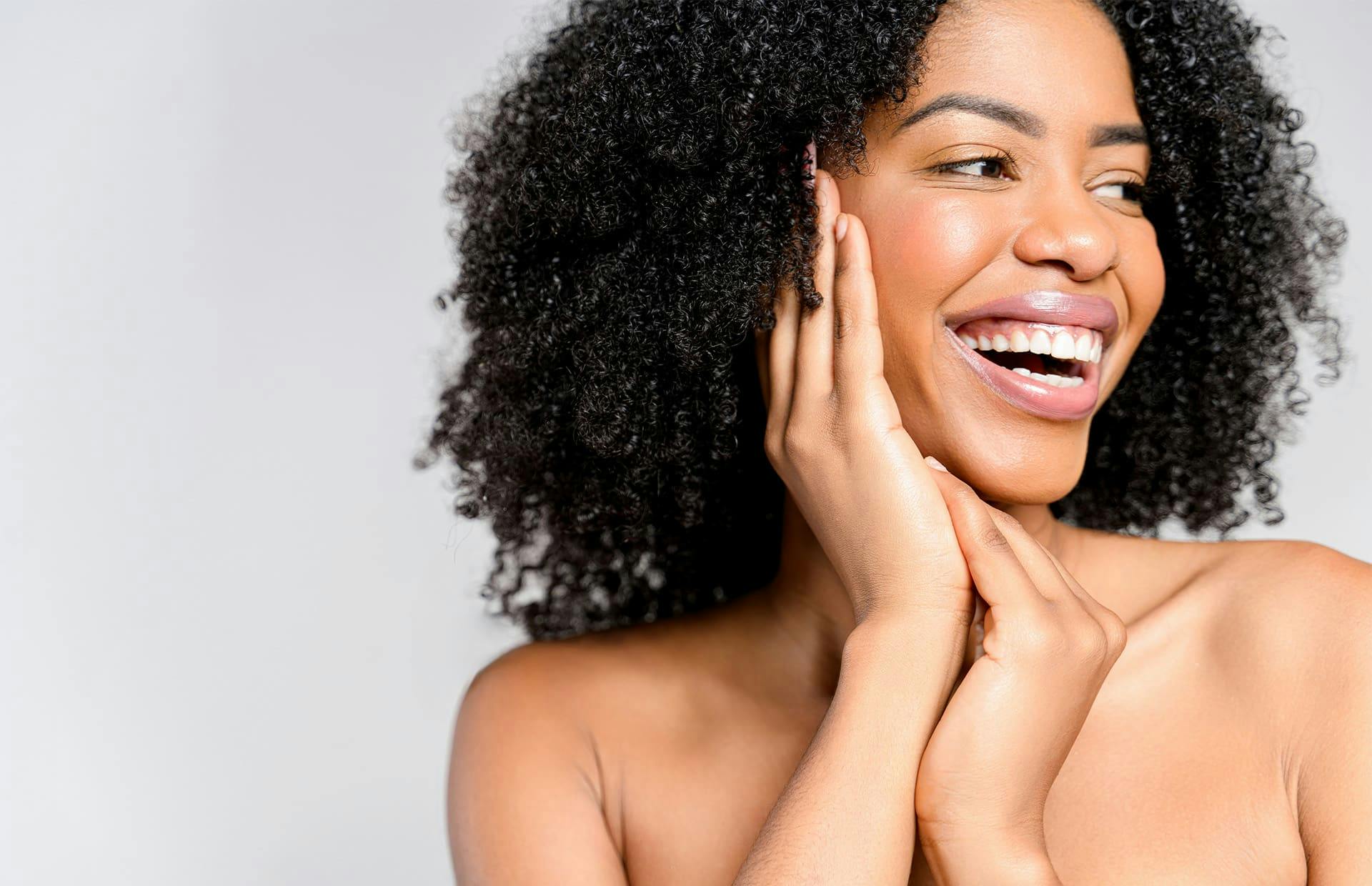 Woman laughing touching face