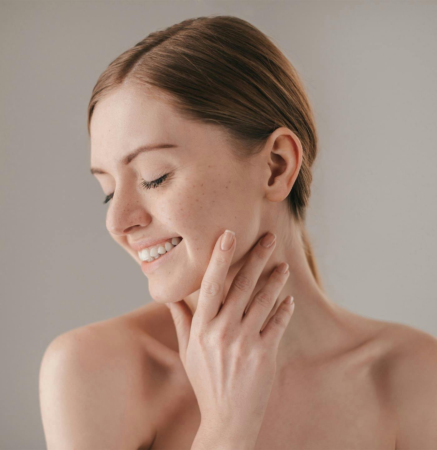 Woman smiling touching cheek