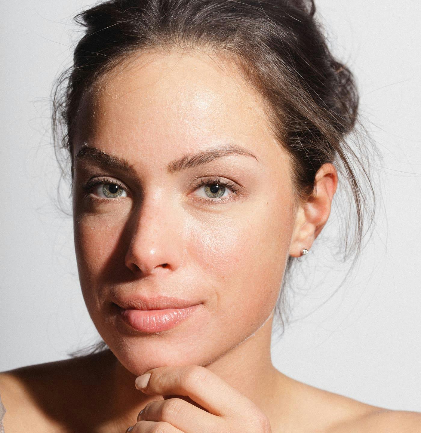 Woman touching chin and smiling