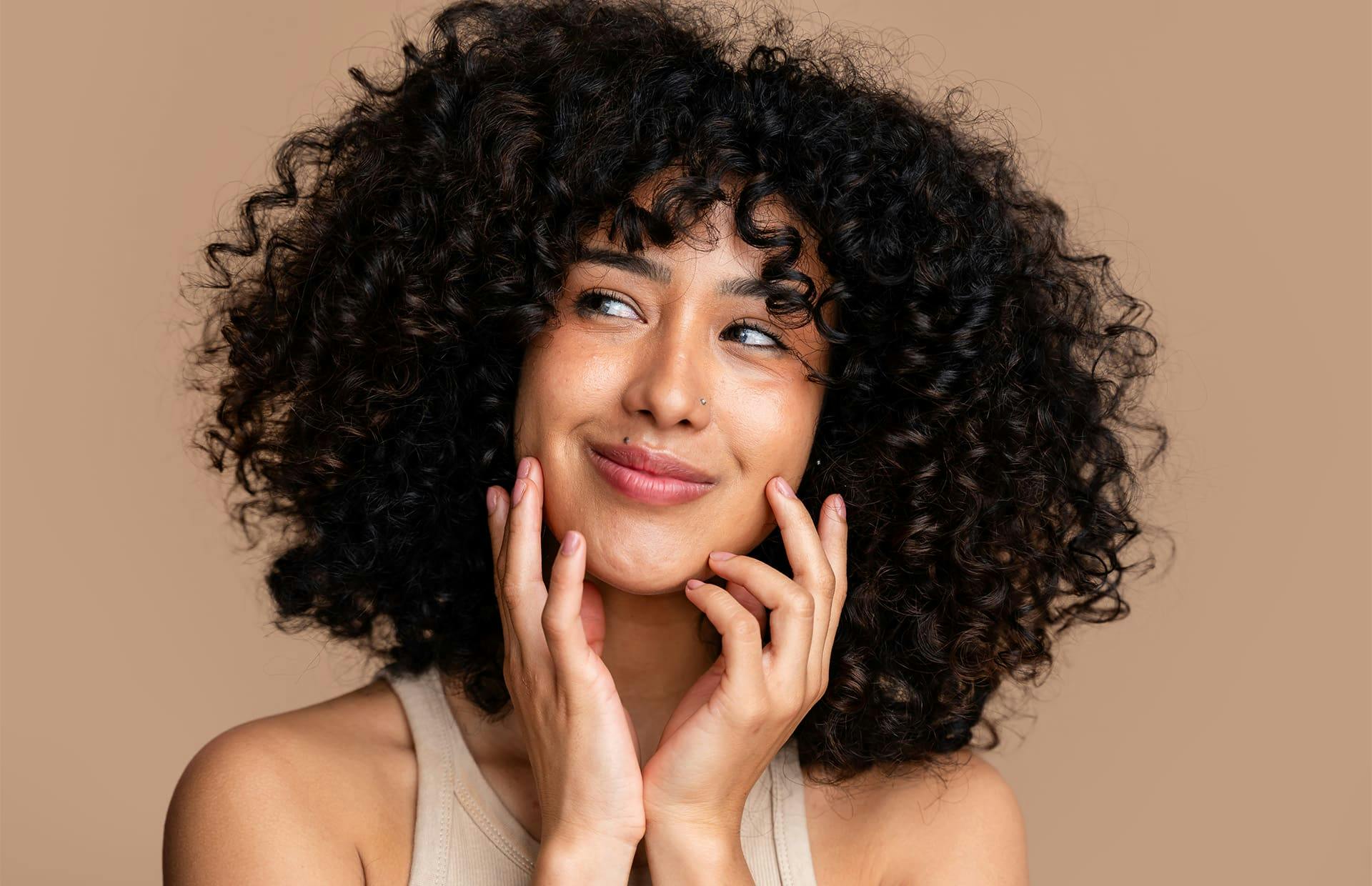 Woman smiling touching cheeks