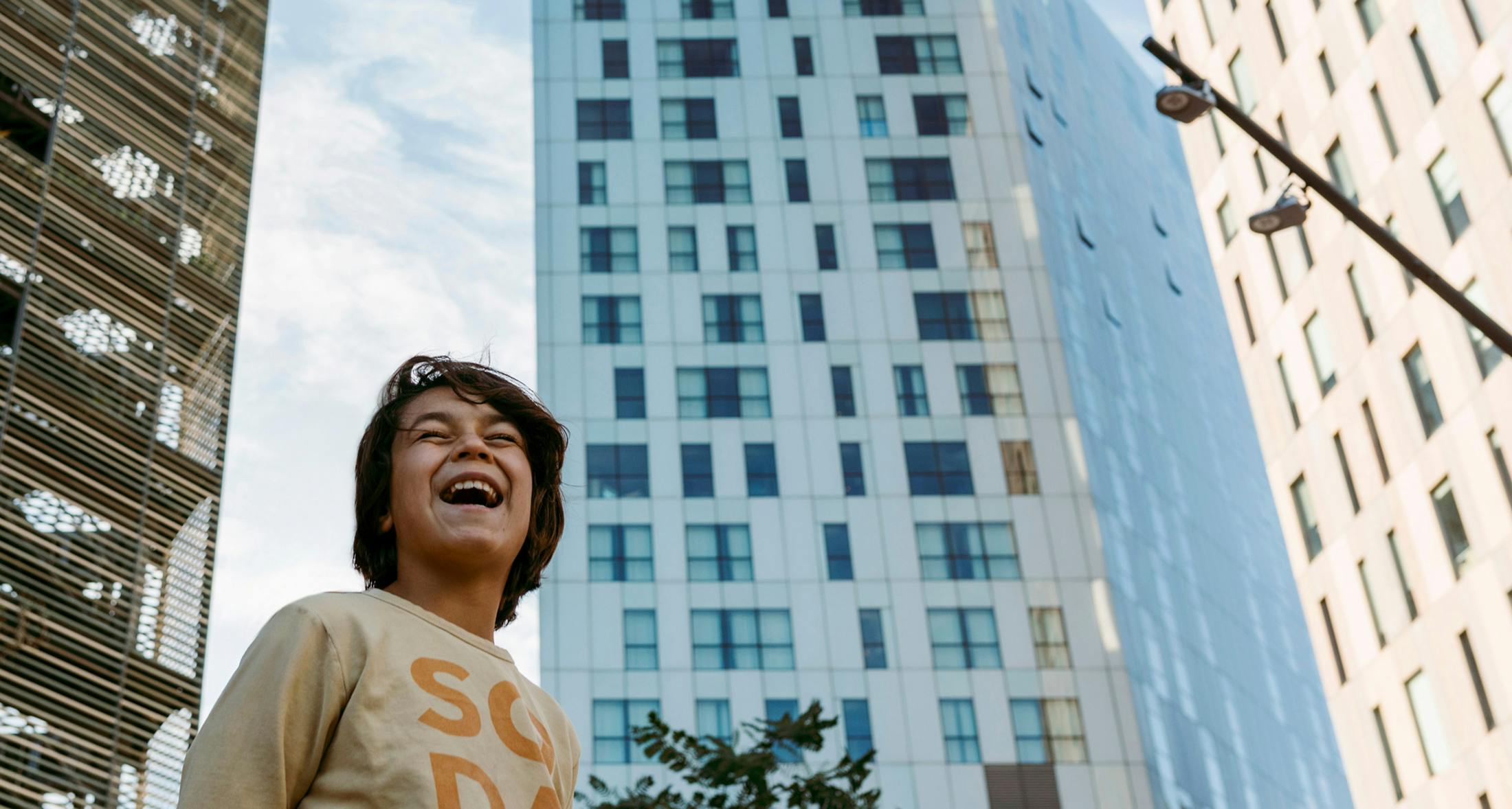Laughing child in front of Miami skyscrapers