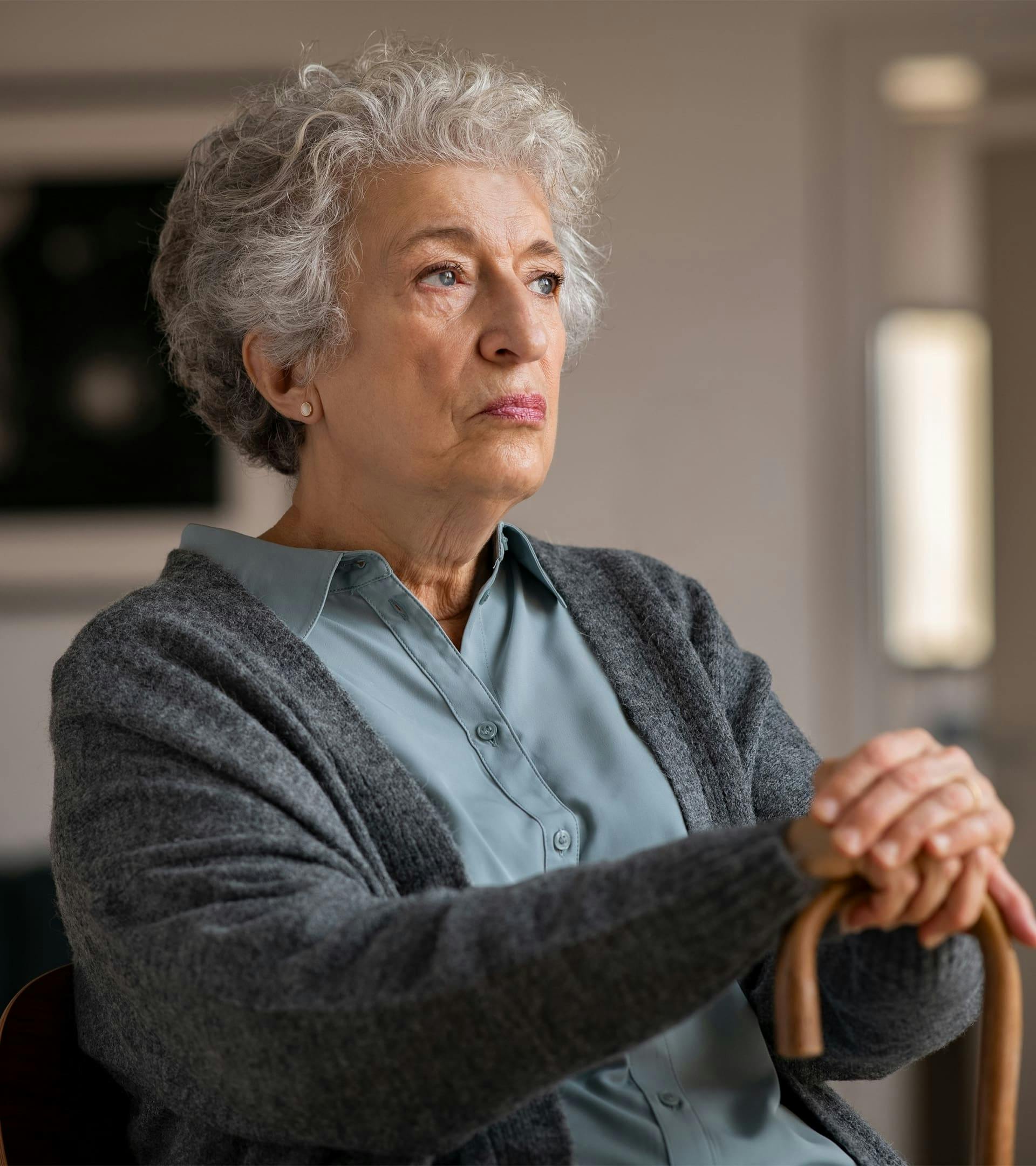Woman with cane sitting down