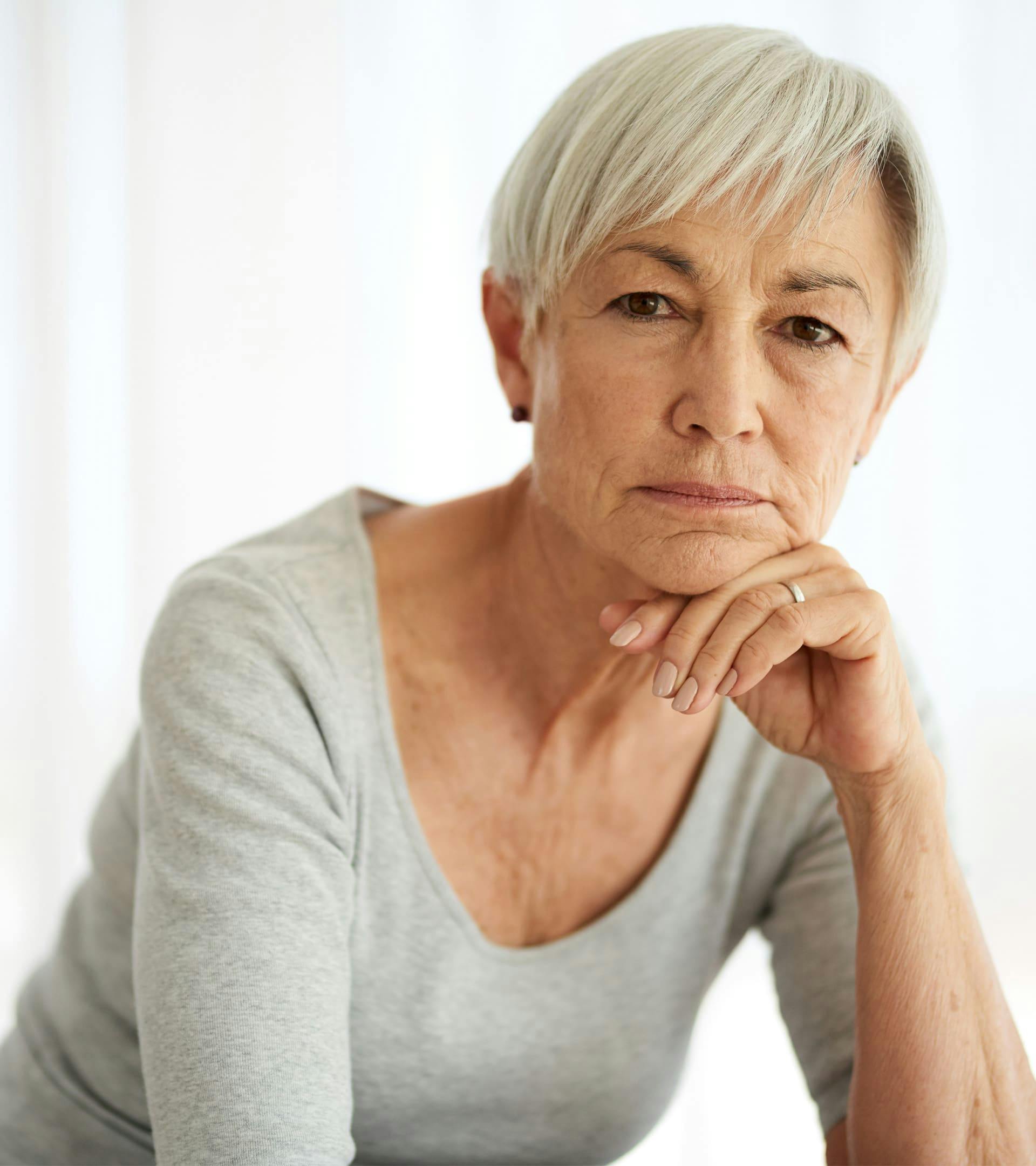Woman resting chin on hand