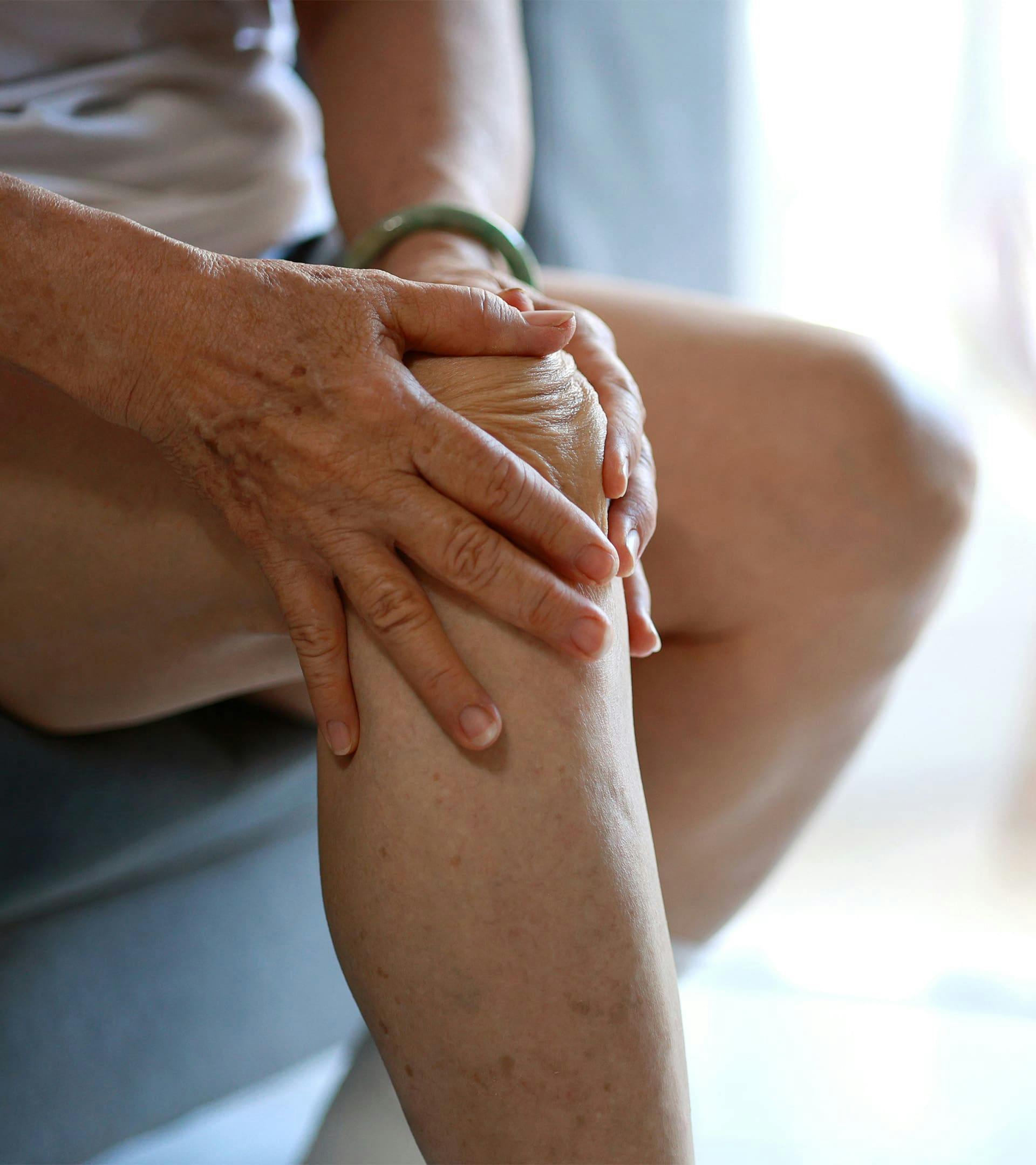 Person holding their knee