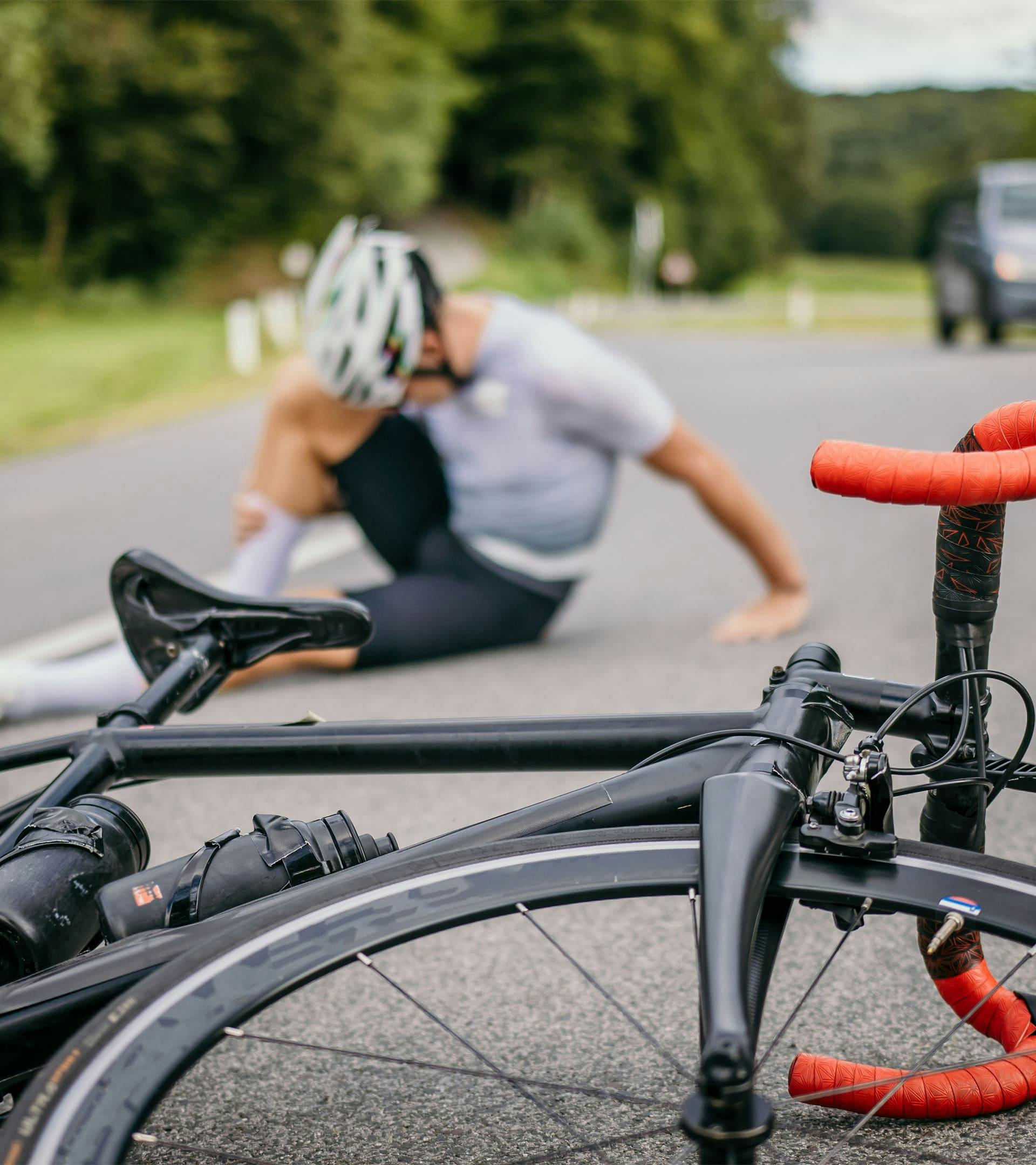 Bicycle and rider on the ground