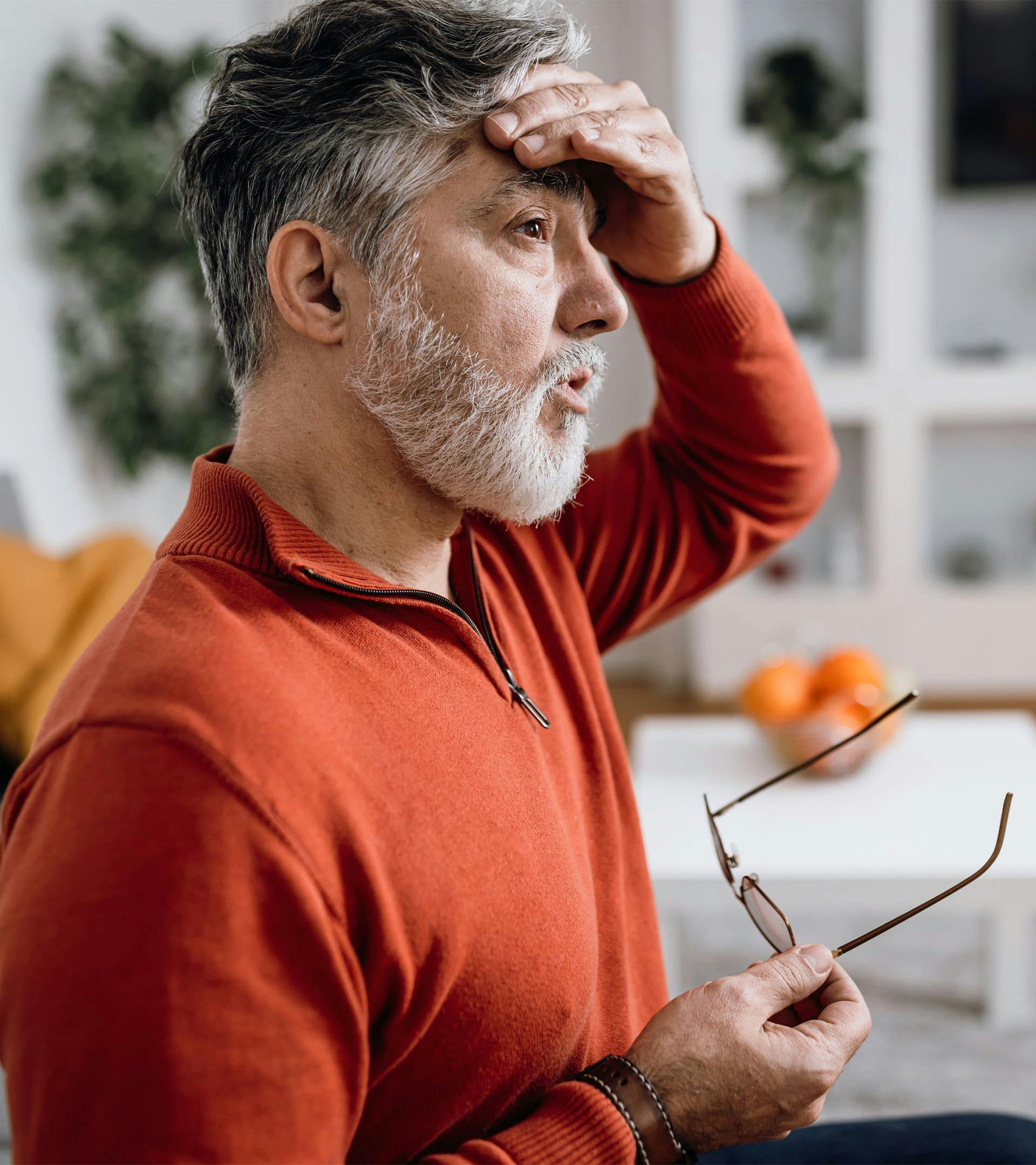 A man touching his forehead