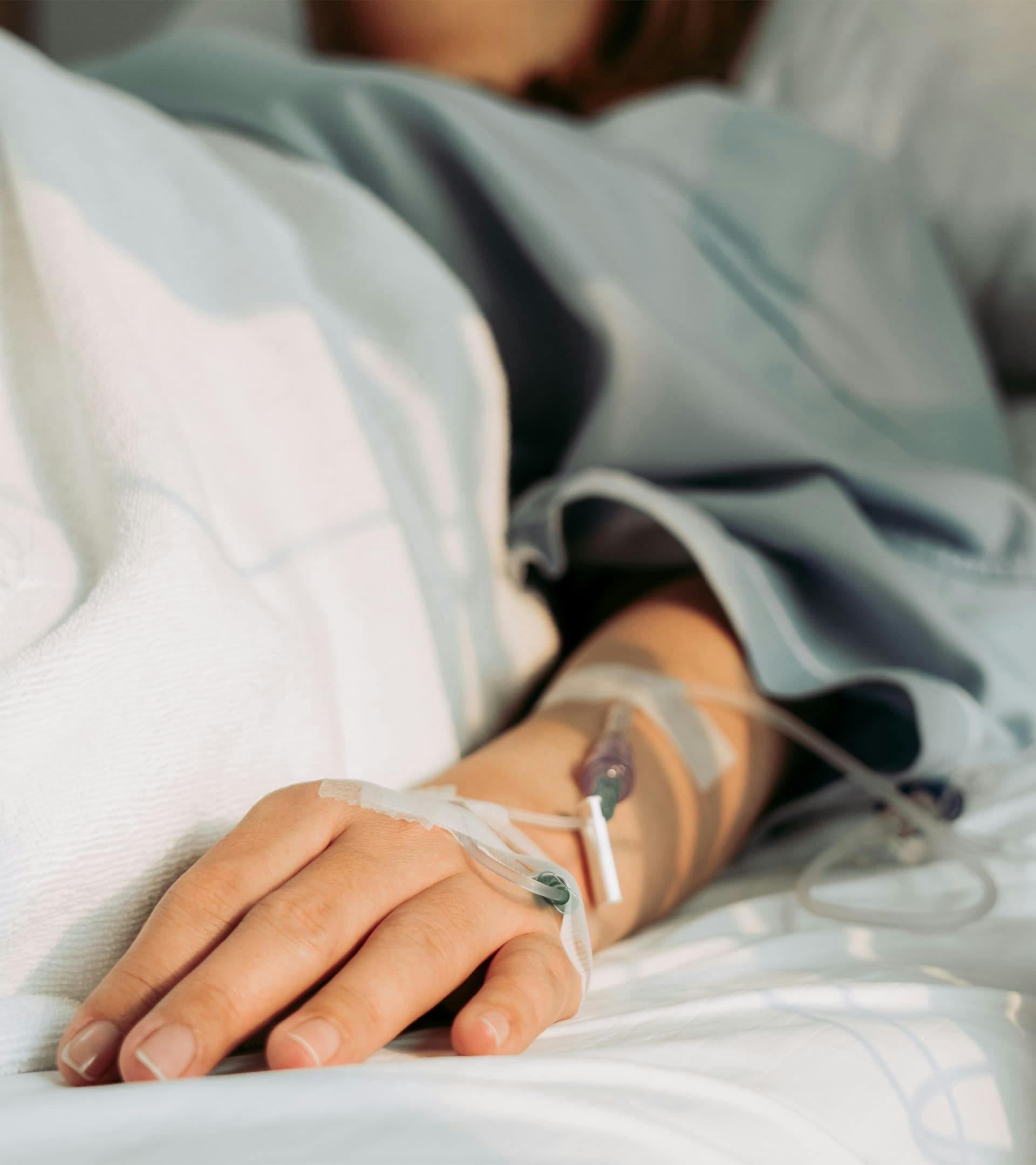 A persons hand with an IV