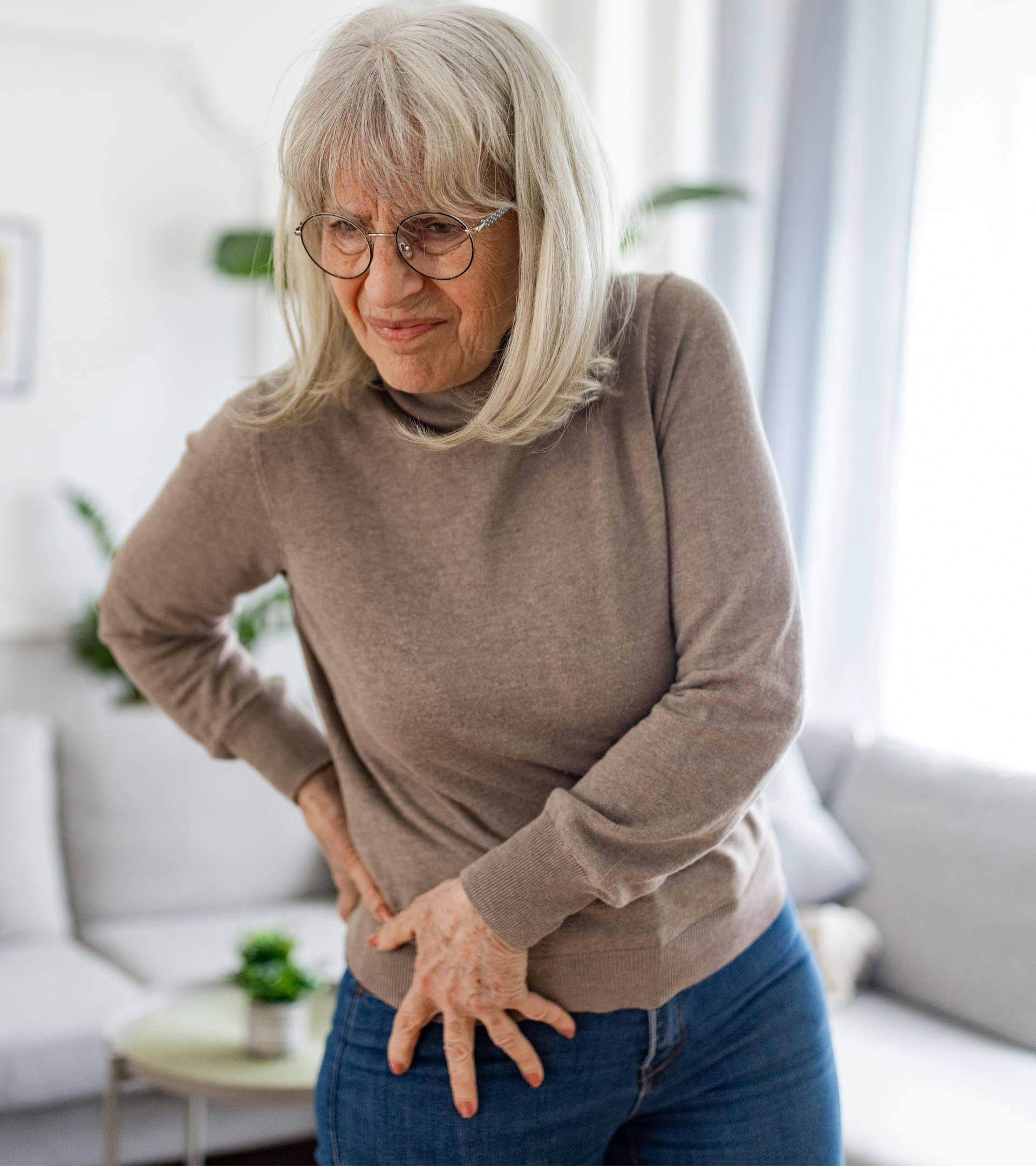 Woman holding hip in pain