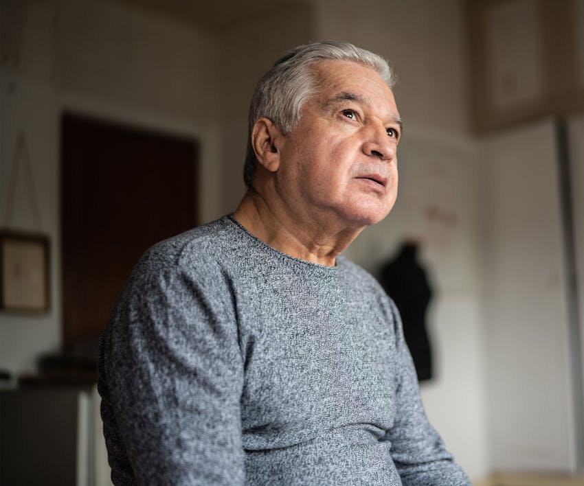 Man sitting slouched over looking sad