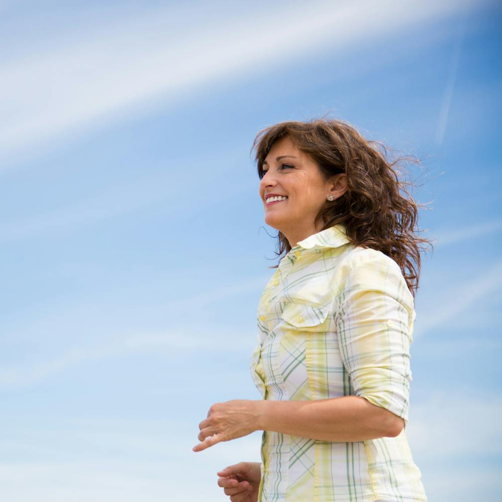 woman wearing a yellow and white shirt