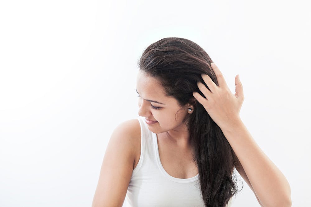 young-and-beautiful-indian-woman-styling-her-hair