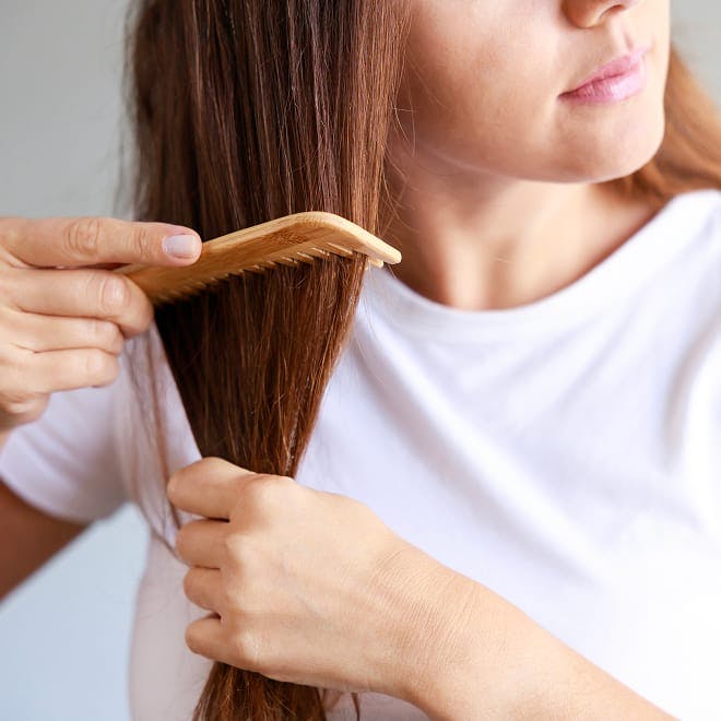 woman combing her hair