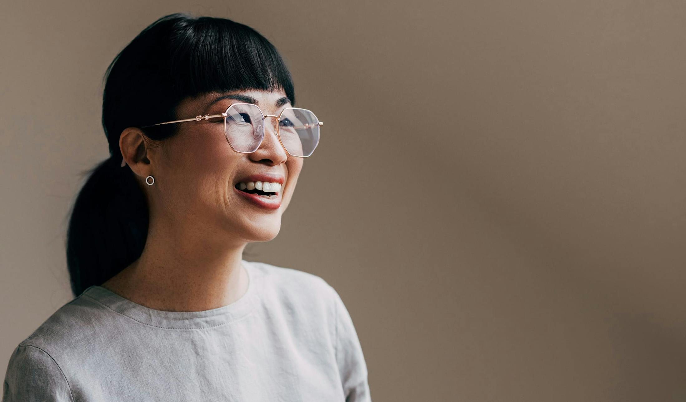 woman wearing glasses and smiling