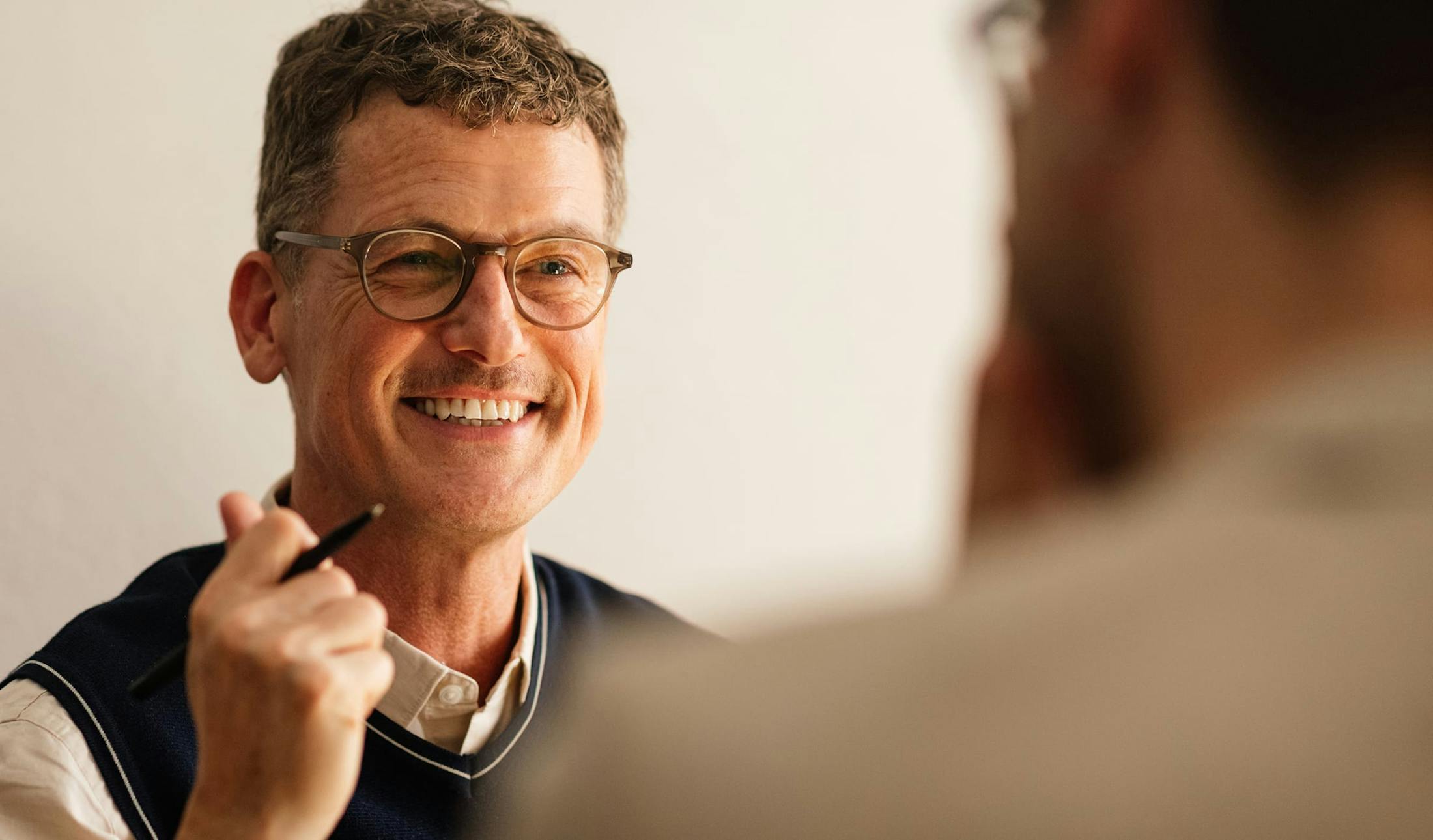 man wearing glasses and a vest