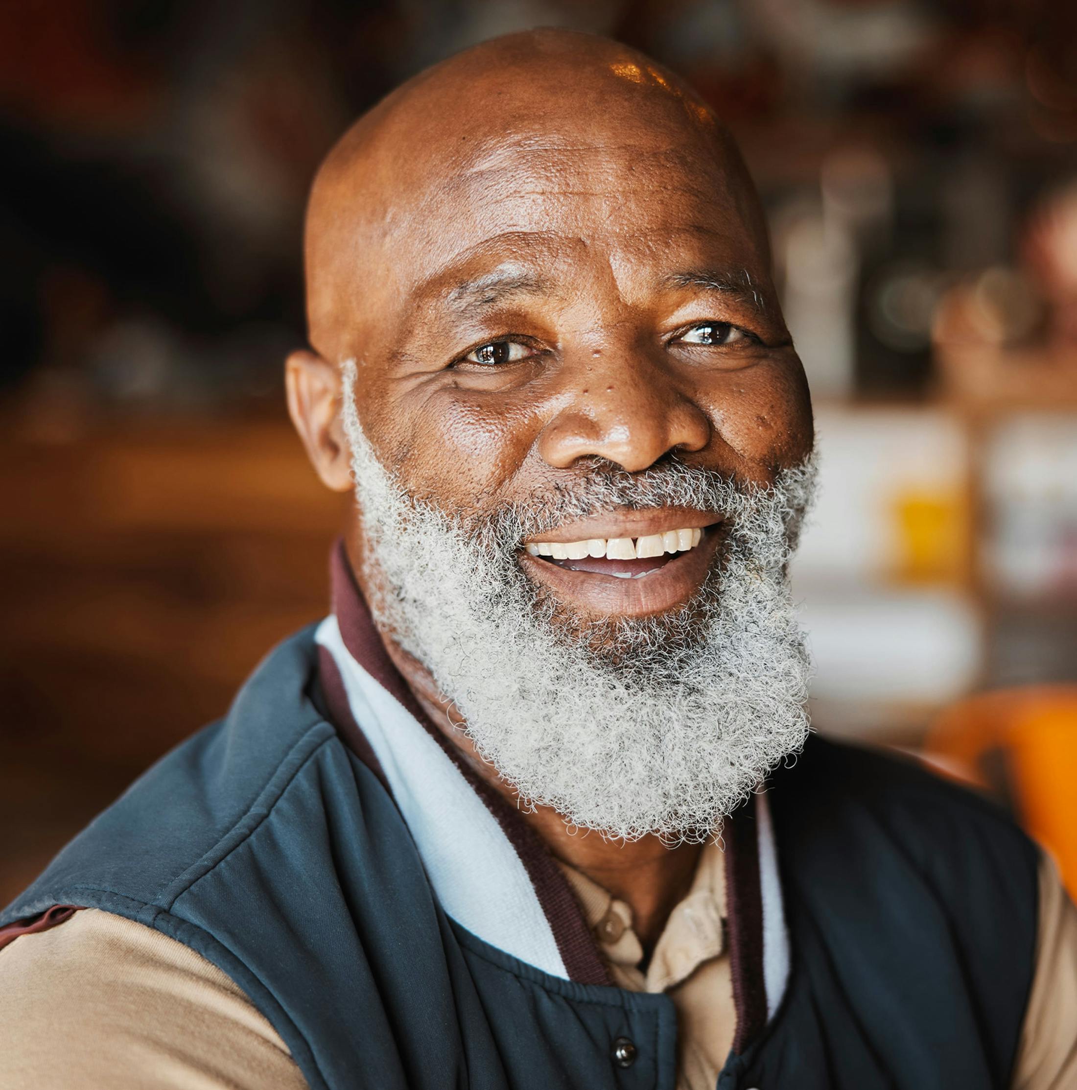 older man with long white beard smiling