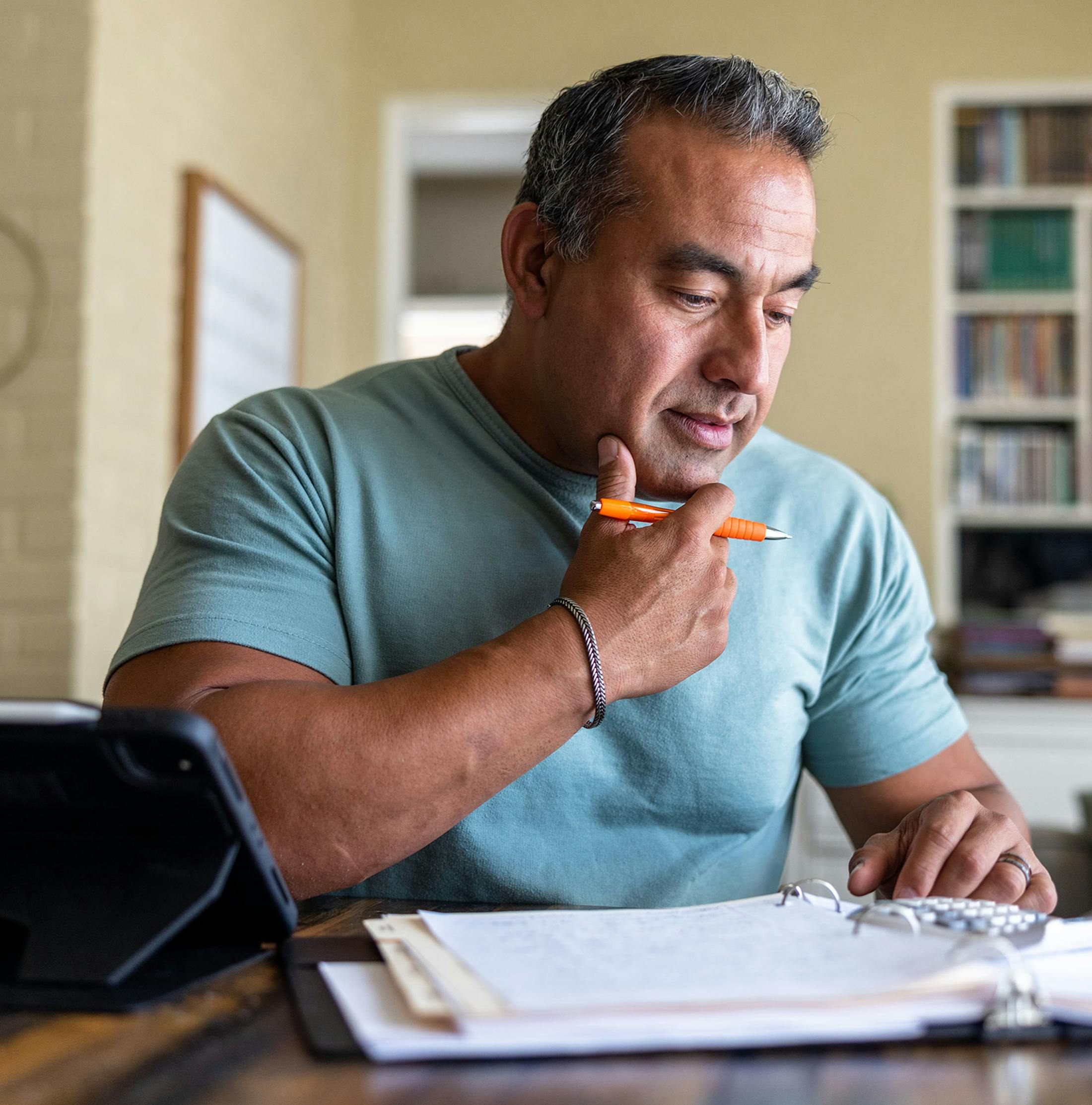 man filling out paperwork at the table