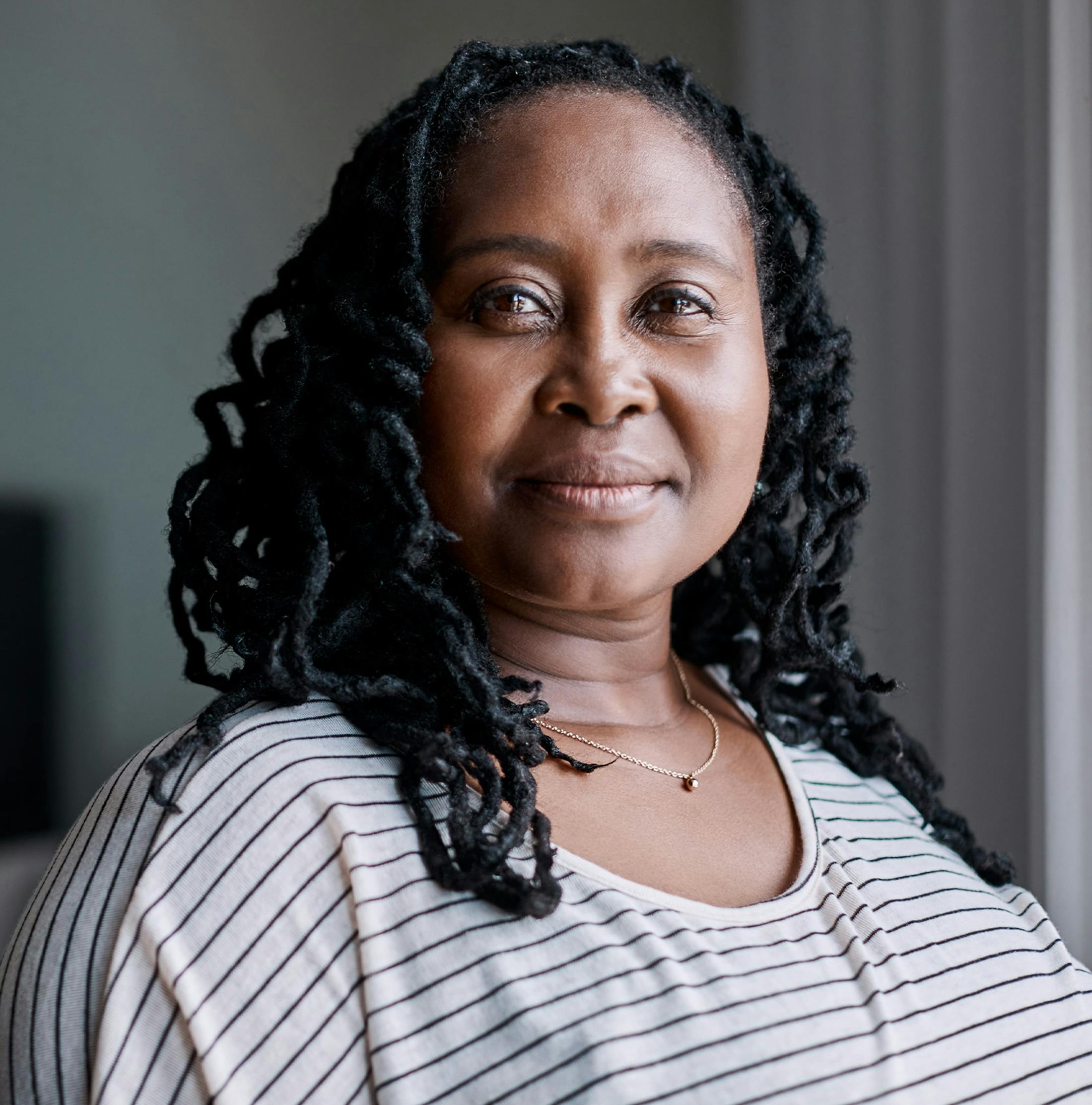 woman with curly dreads looking forward