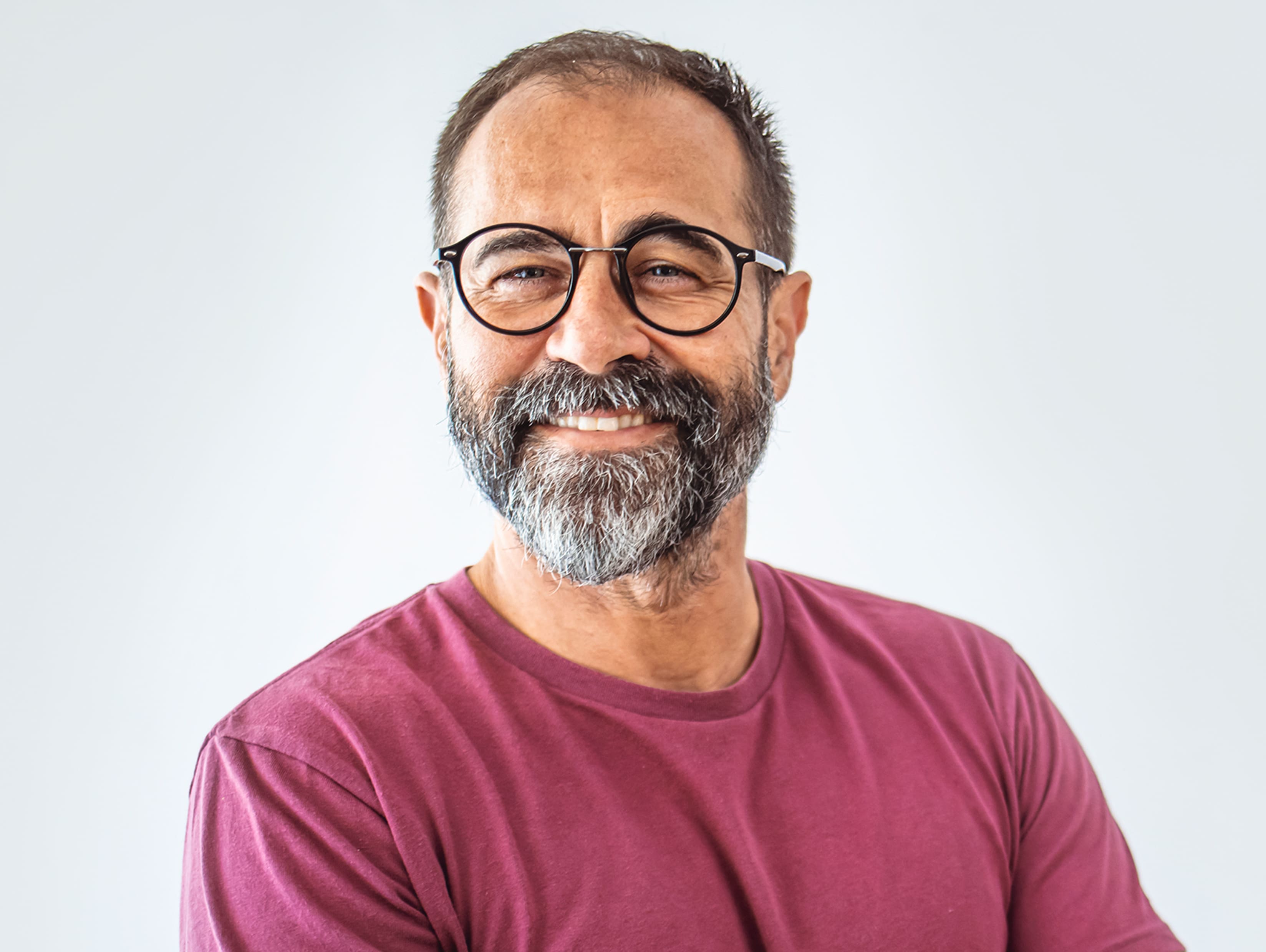 man smiling in maroon shirt