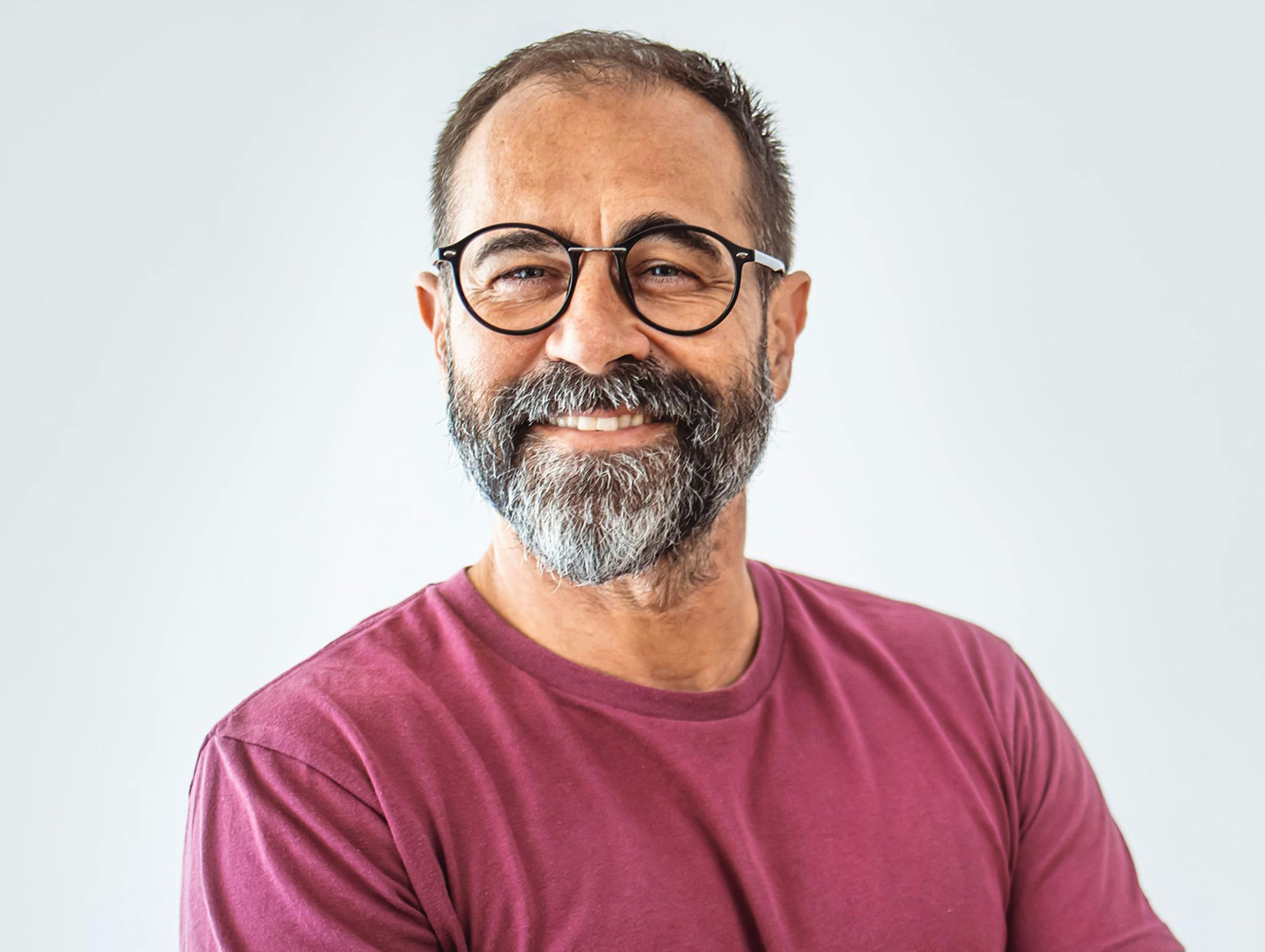 man smiling in maroon shirt