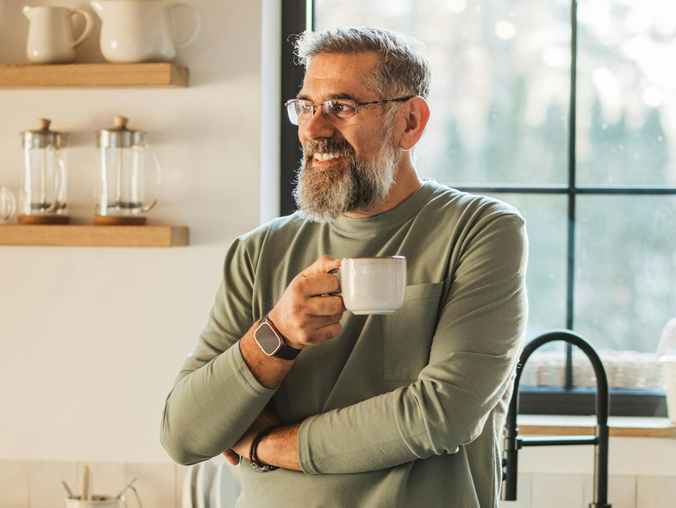 man in a long sleeve shirt drinking coffee