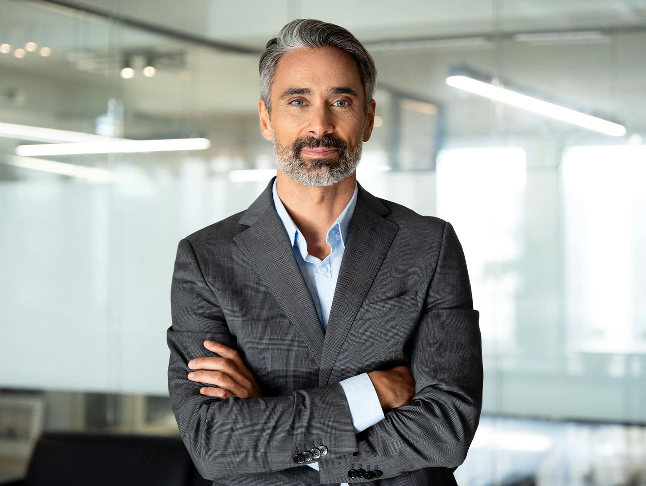 man in suit jacket crossing his arms