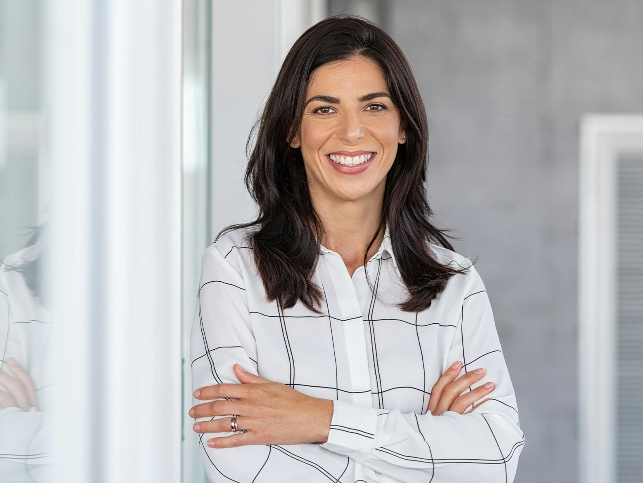 woman with her arms crossed and smiling
