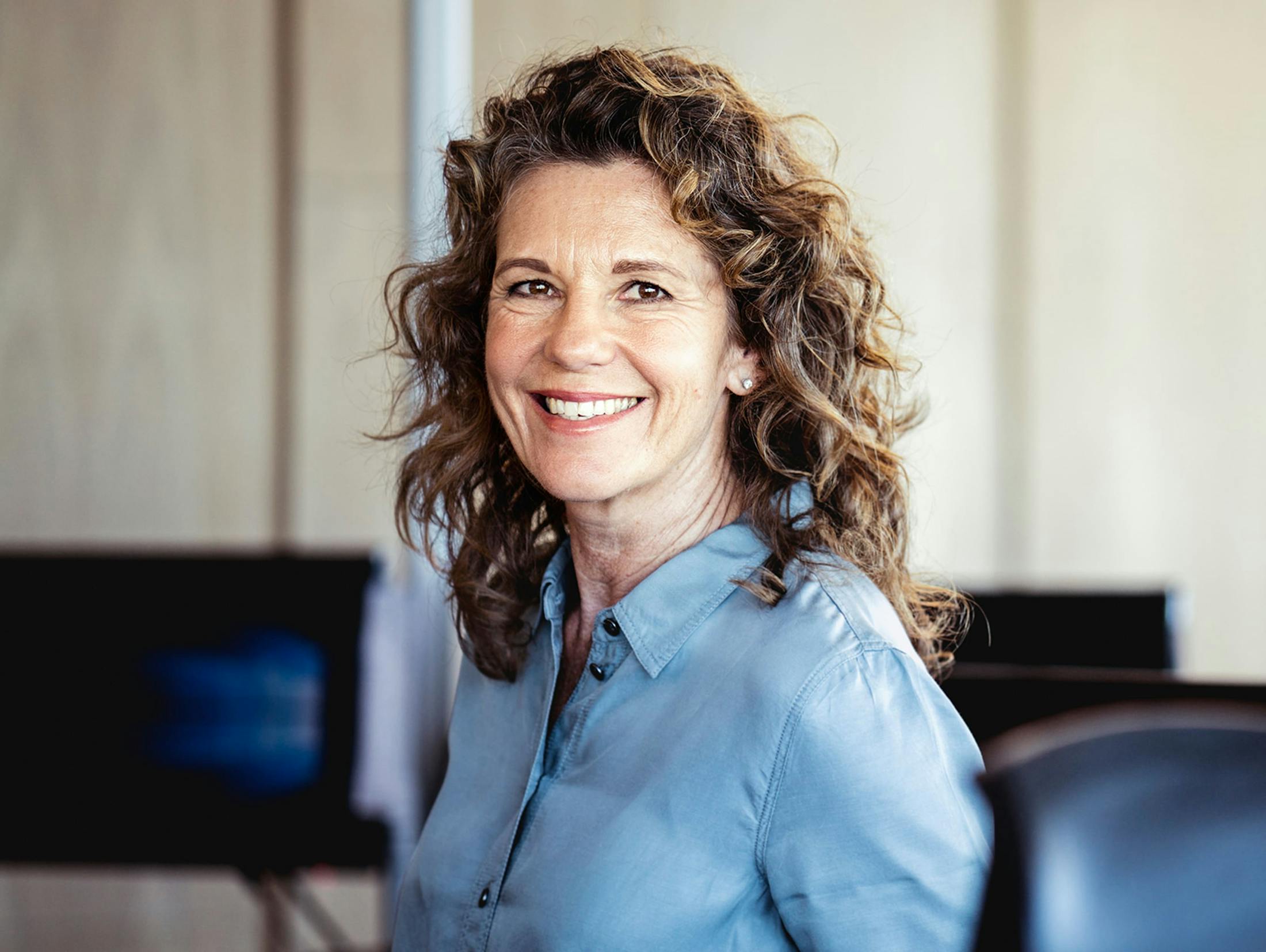 woman with curly hair smiling