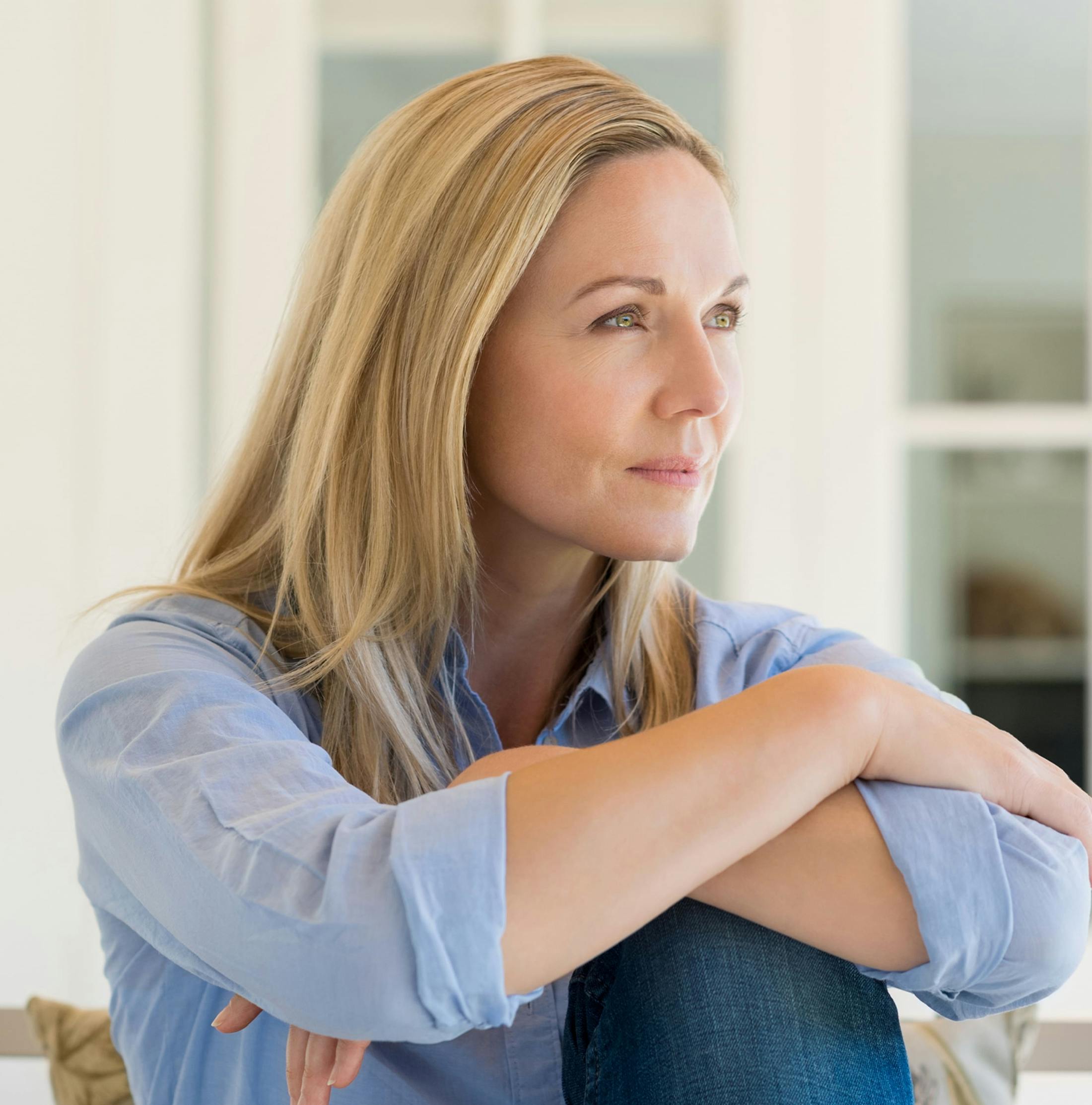 woman resting arms on her bent knee