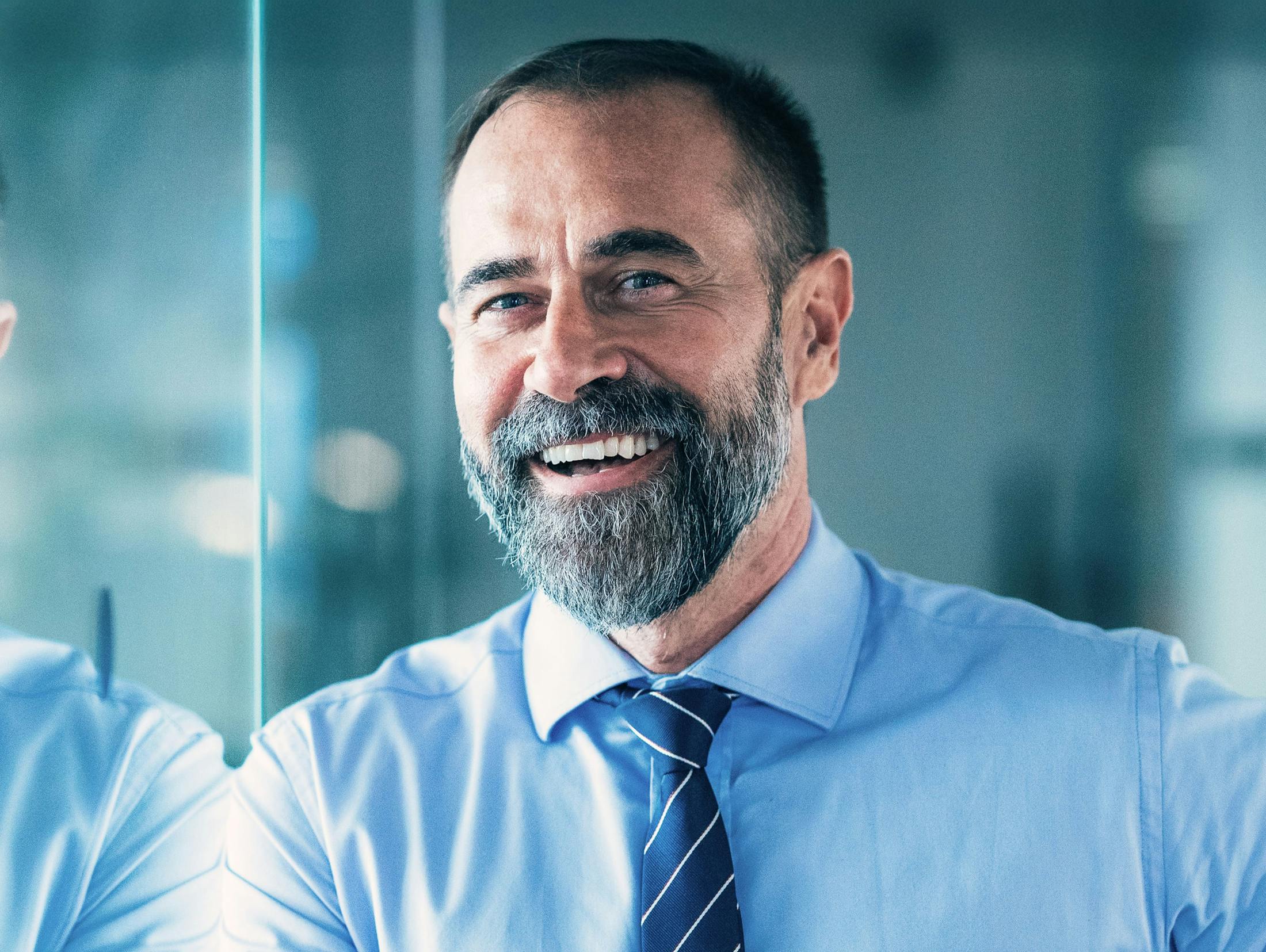man smiling while wearing a tie