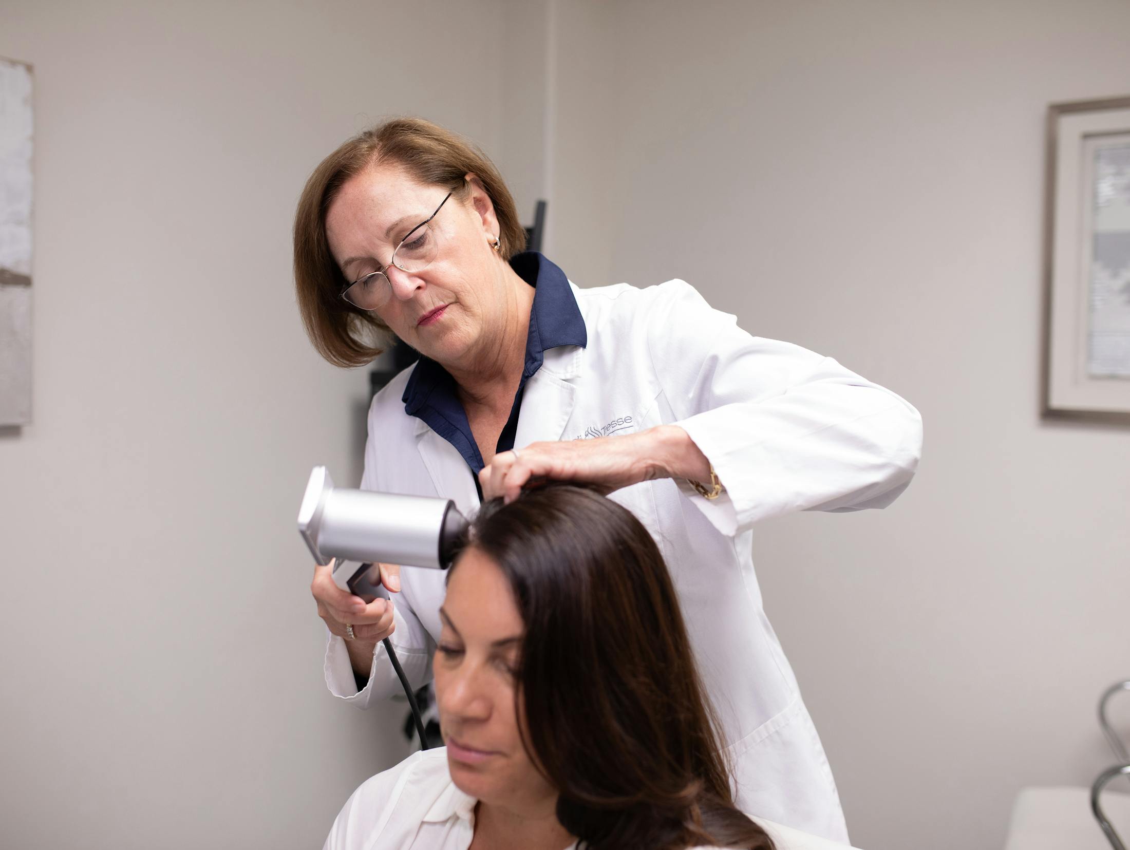 woman smiling while drying her hair with a towel