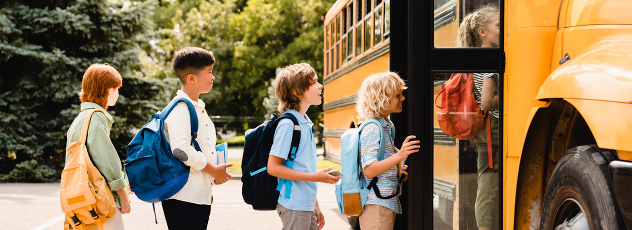 Kids lining up outside a school bus