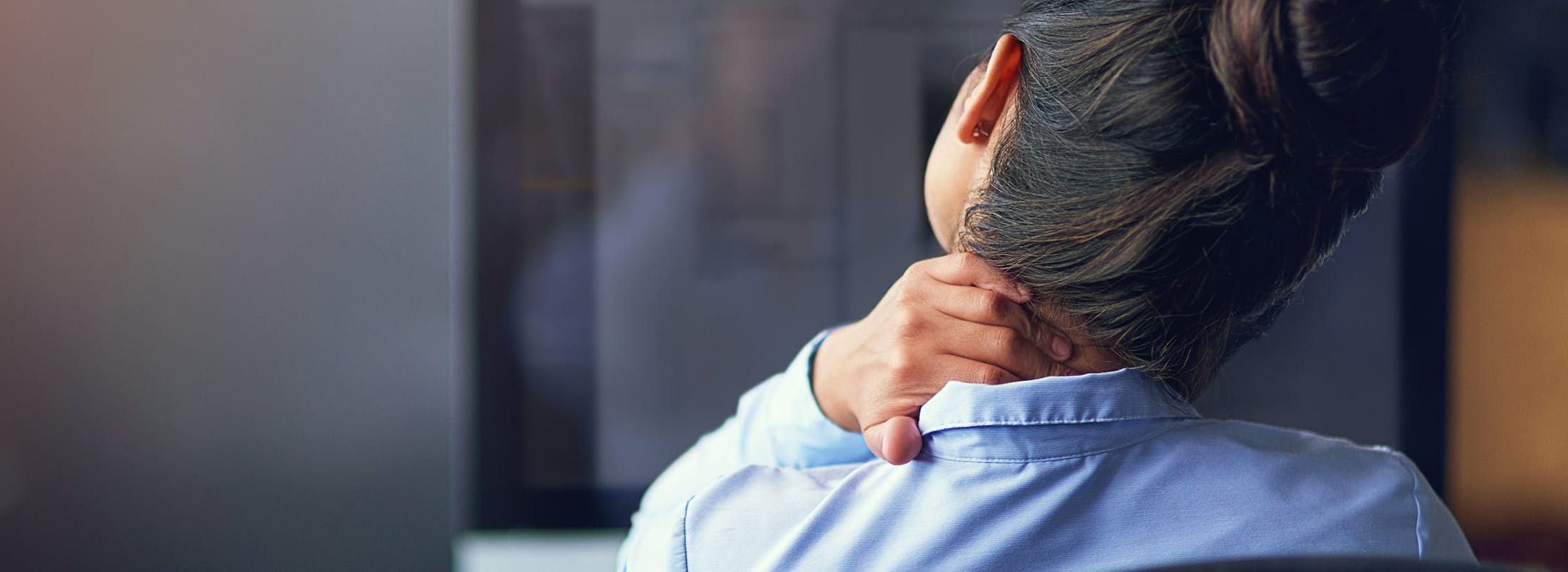 Woman holding her neck in pain